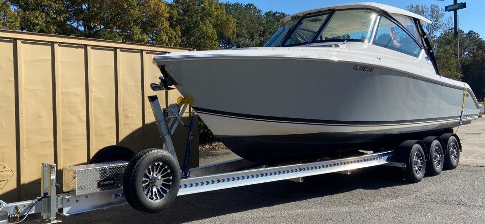 A white boat is sitting on top of a trailer.