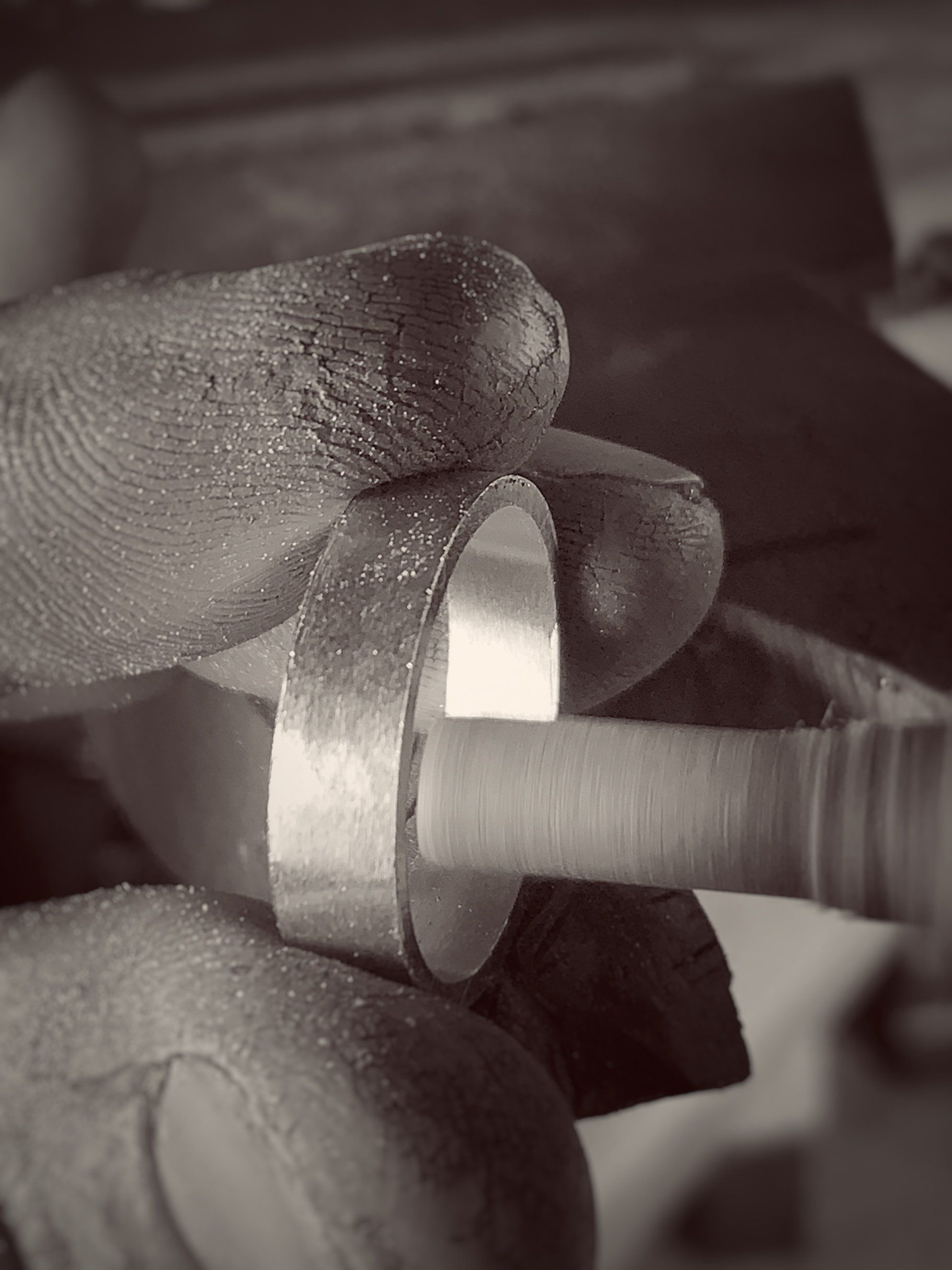 A person is holding a piece of metal in their hand.