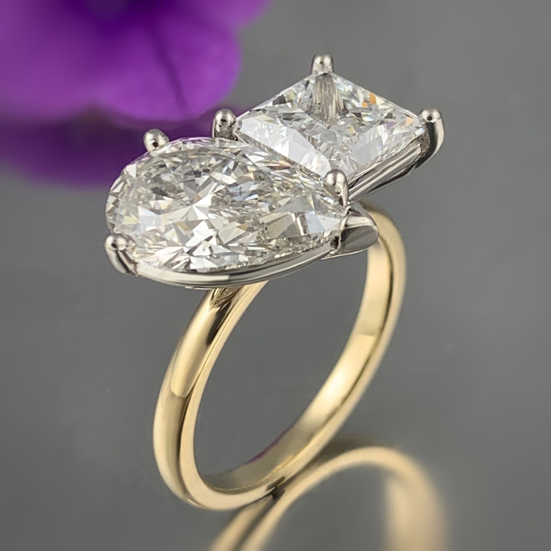 A white gold ring with a square diamond in the center.