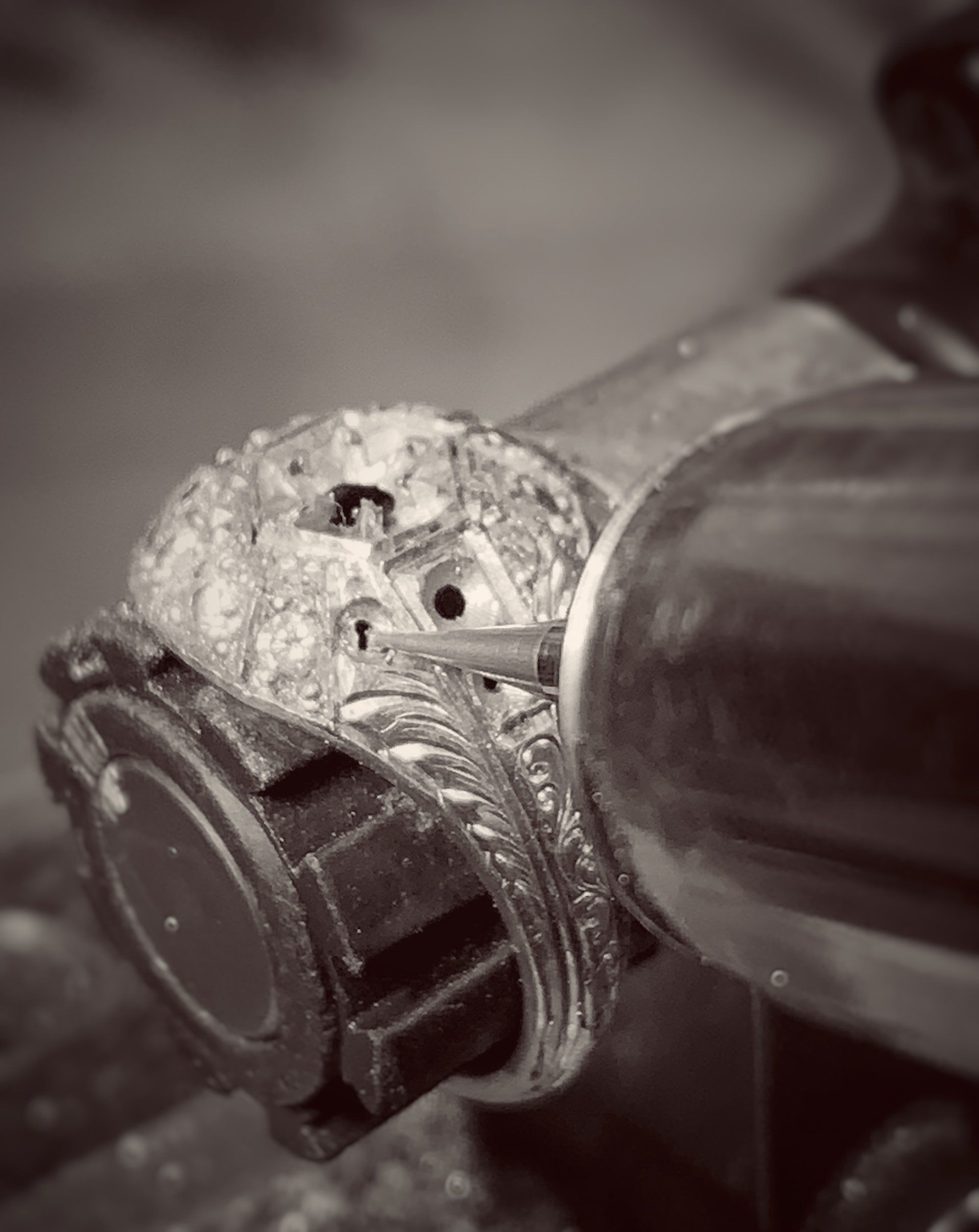 A black and white photo of a ring being made.