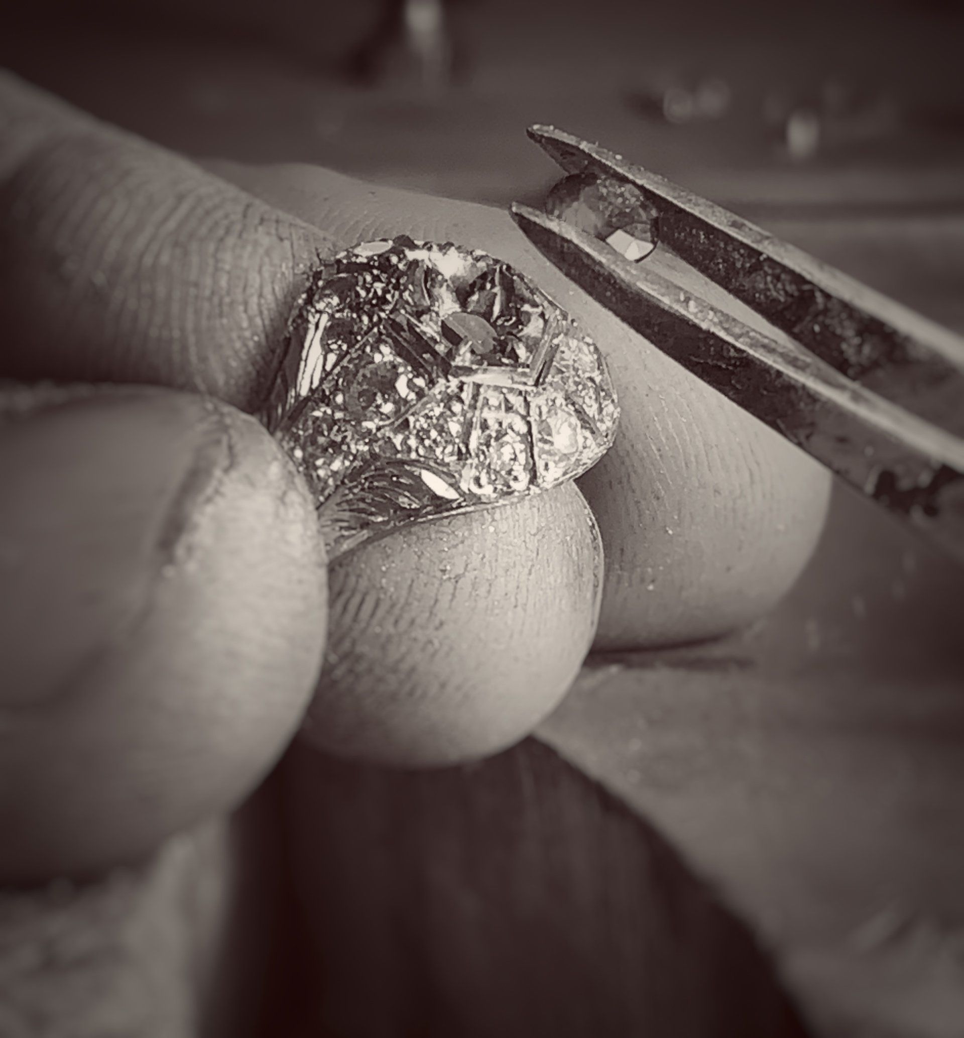 A person is holding a piece of aluminum foil in their hand.