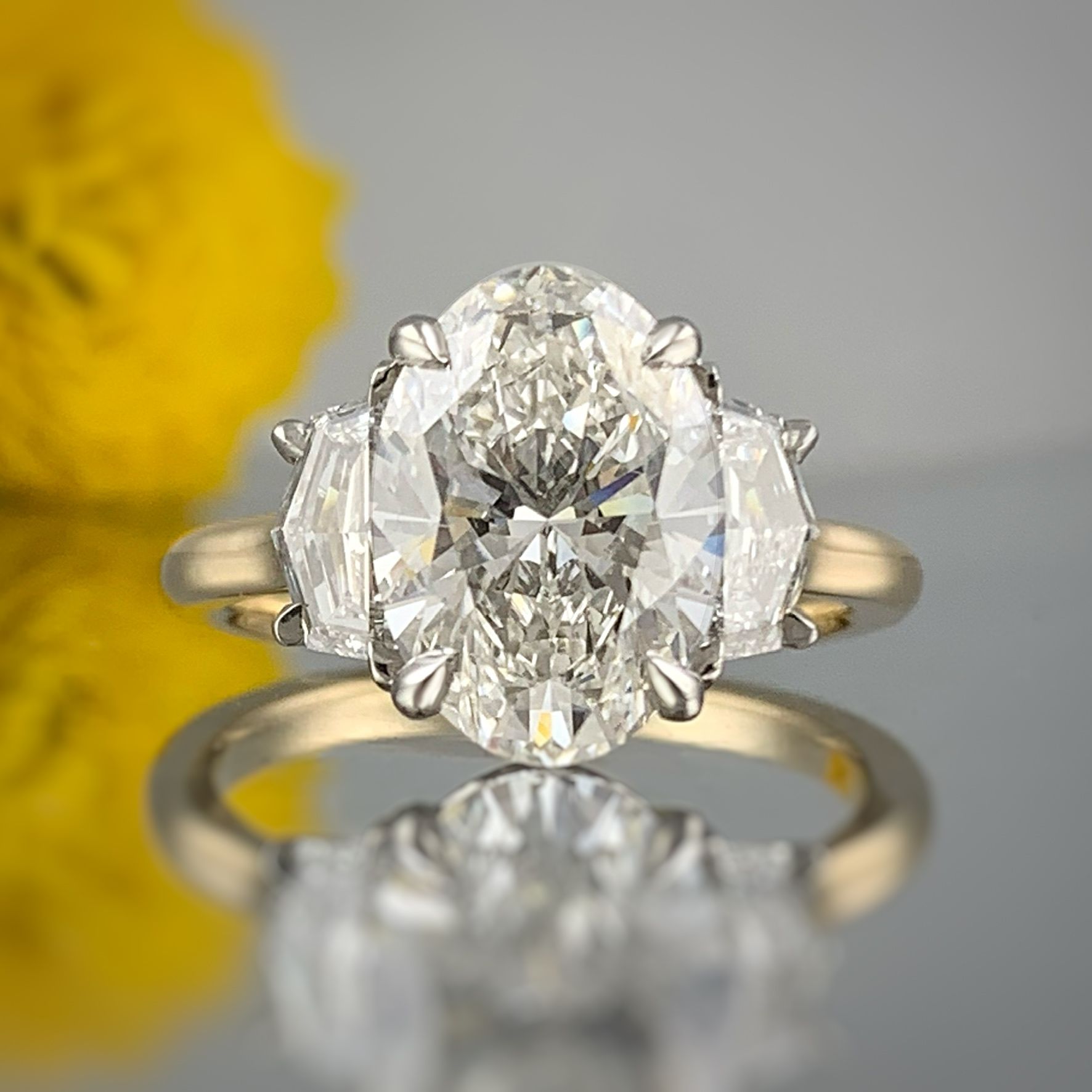 A ring with a diamond in the center is sitting on a table.