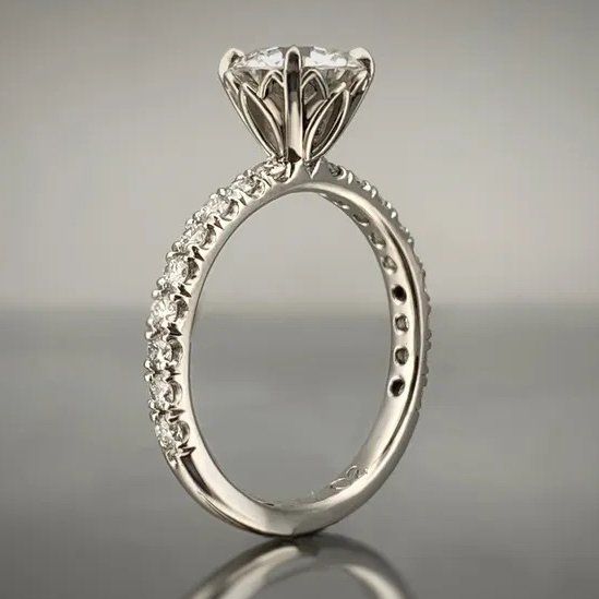 A white gold ring with a diamond in the center