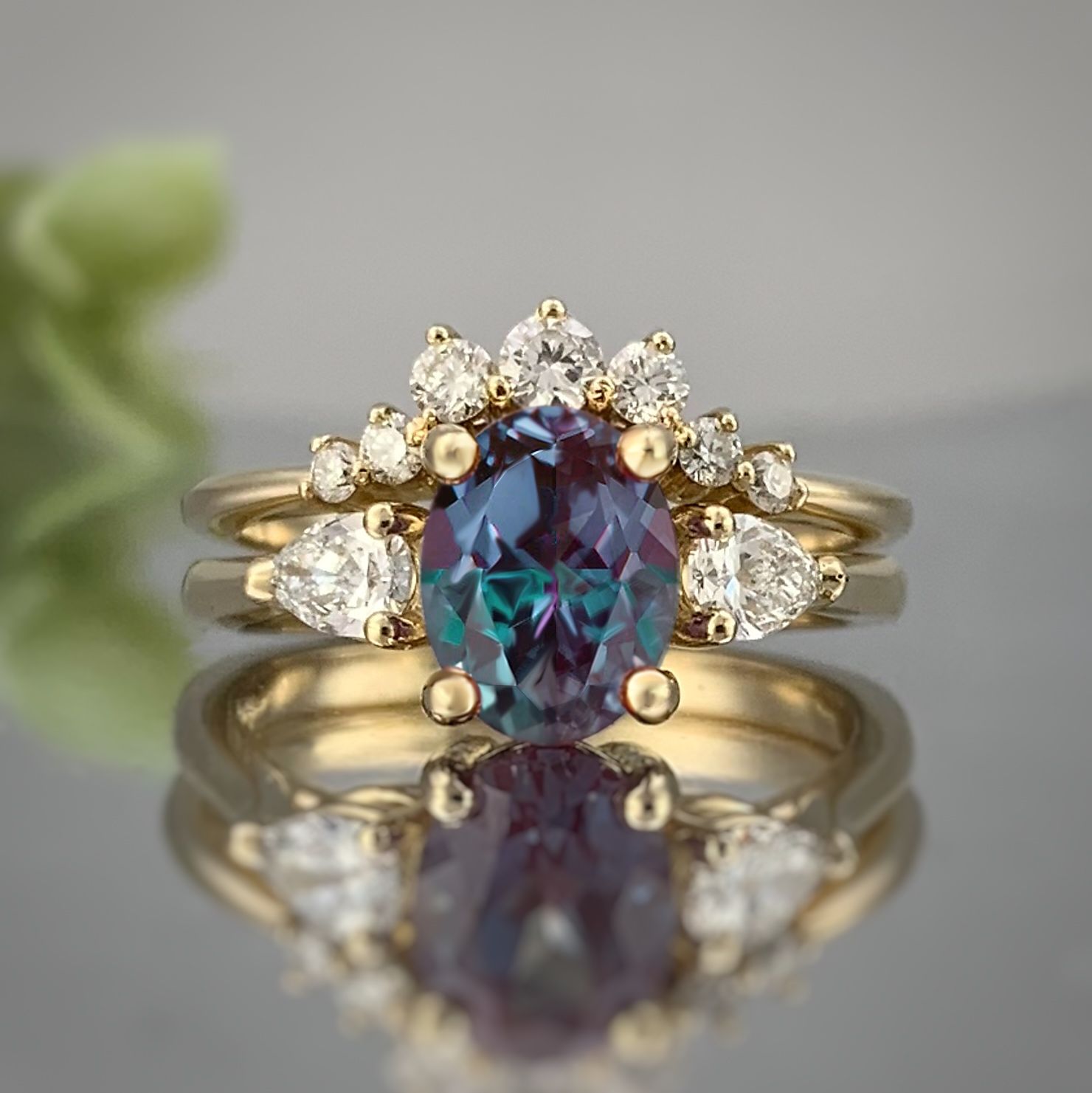 A close up of a ring with a purple stone and diamonds on a table.