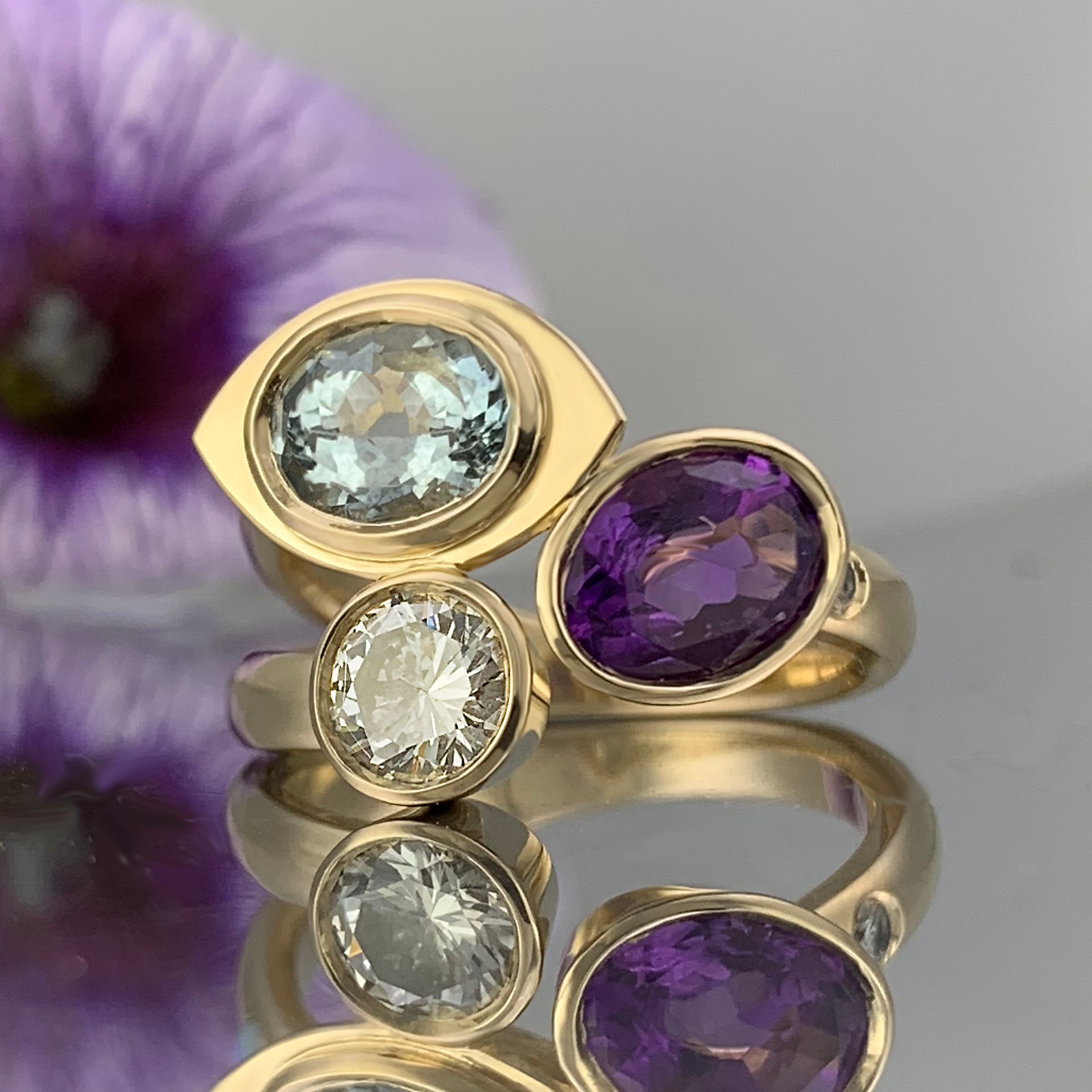 A close up of a ring with purple and blue stones