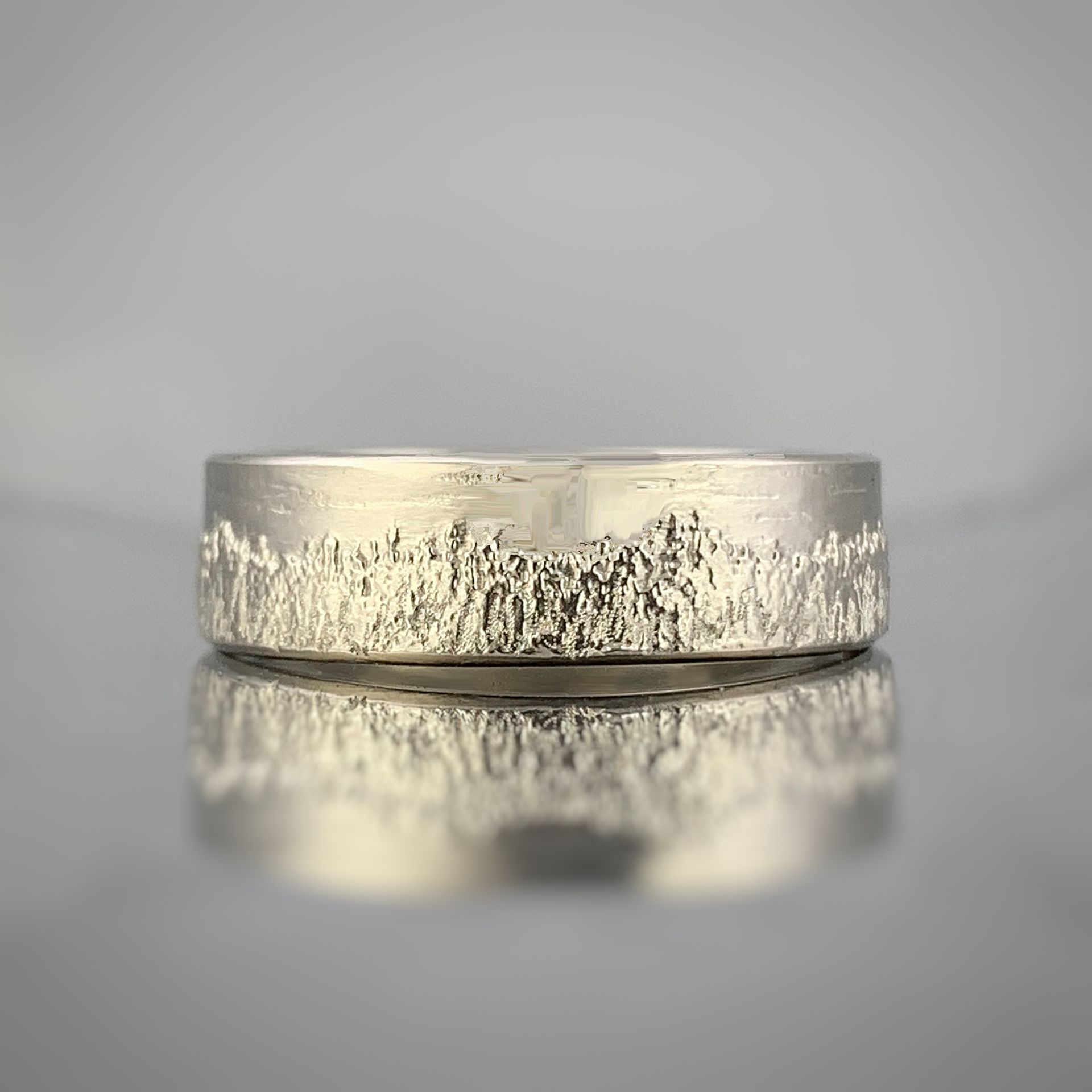 A close up of a silver ring on a table.