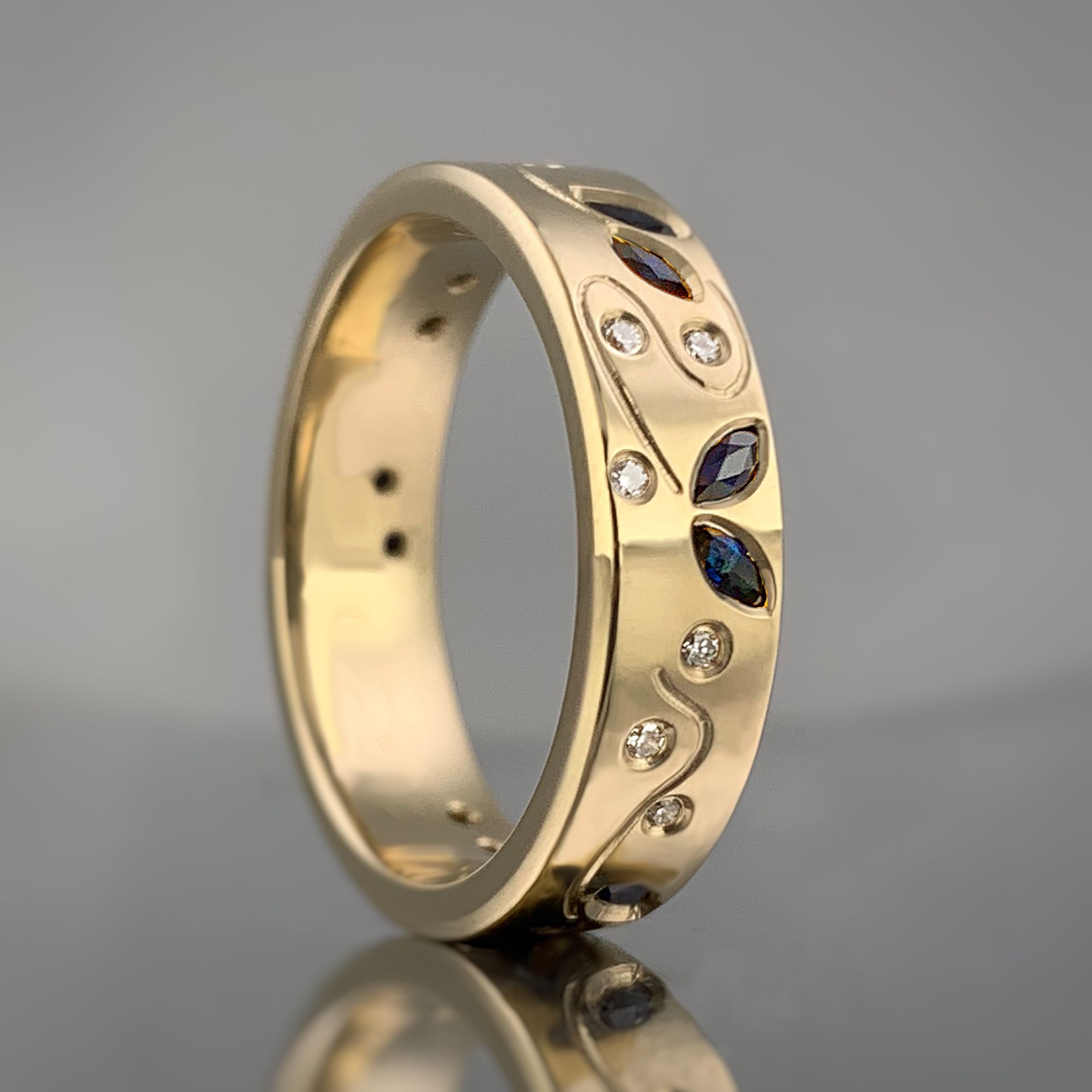 A gold ring with sapphire and diamonds on it