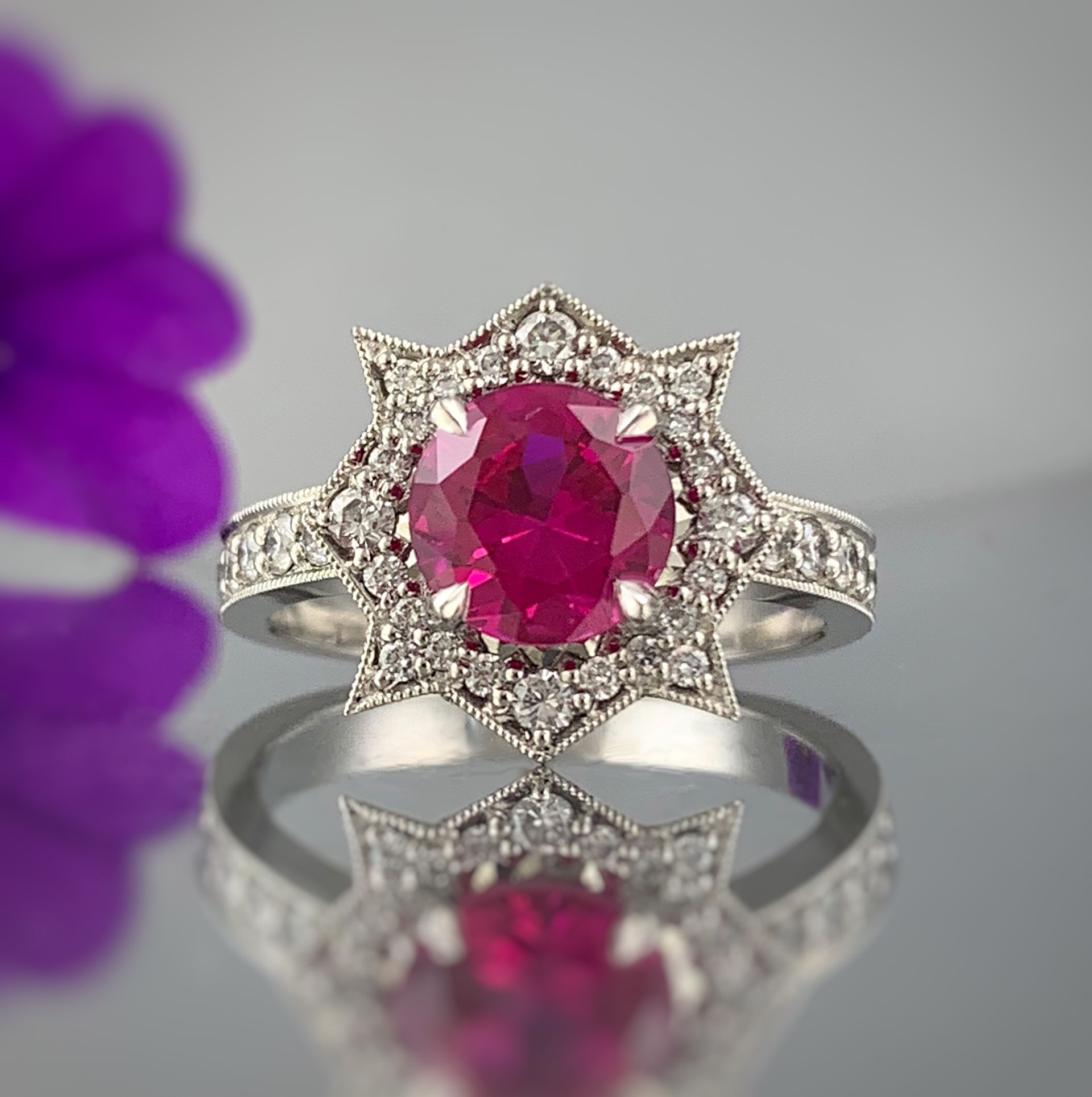 A silver ring with a red stone in the center