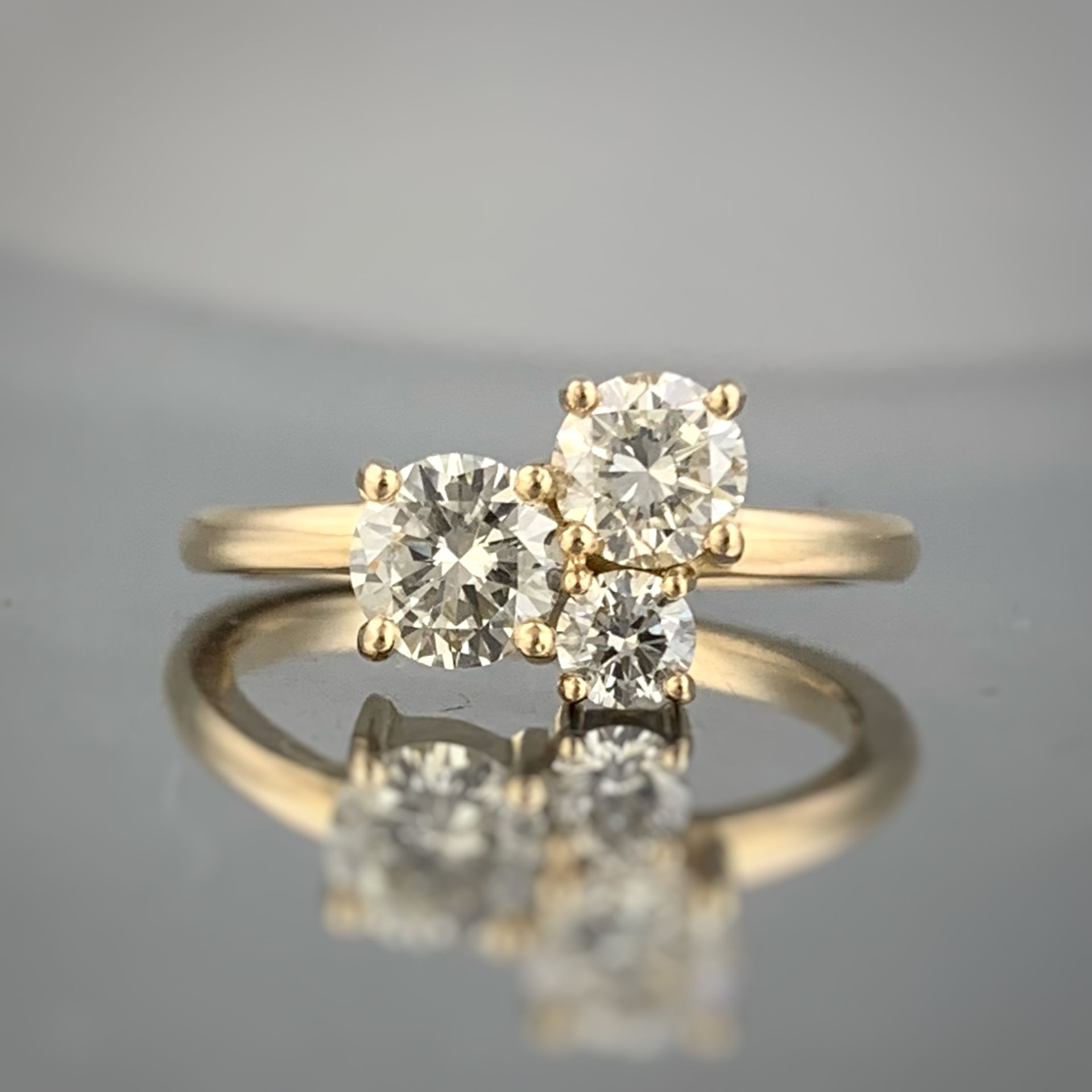 A yellow gold ring with two diamonds on it