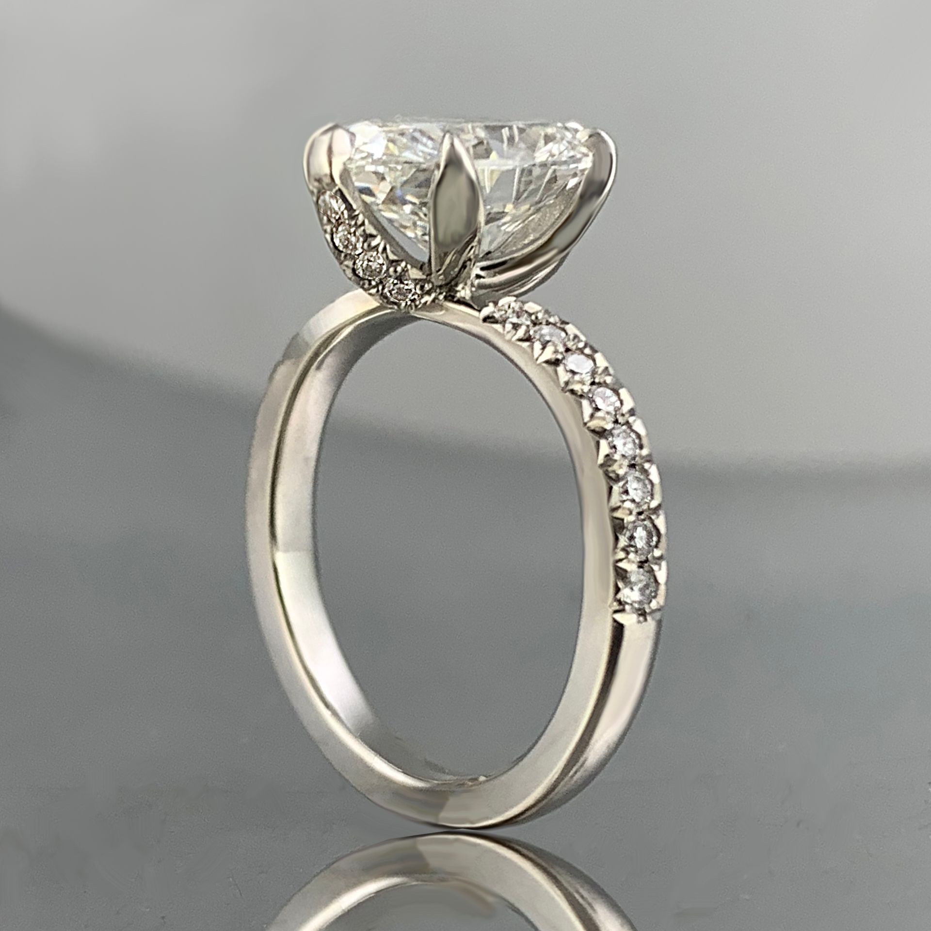 A white gold ring with a large diamond in the center