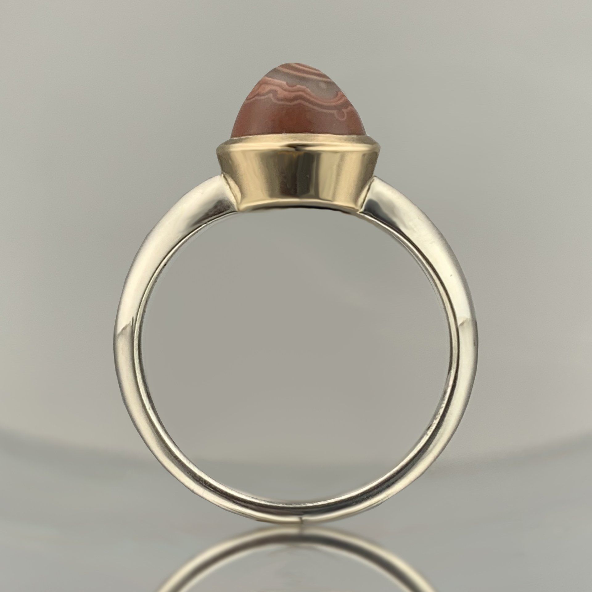 A gold ring with a red stone in the center