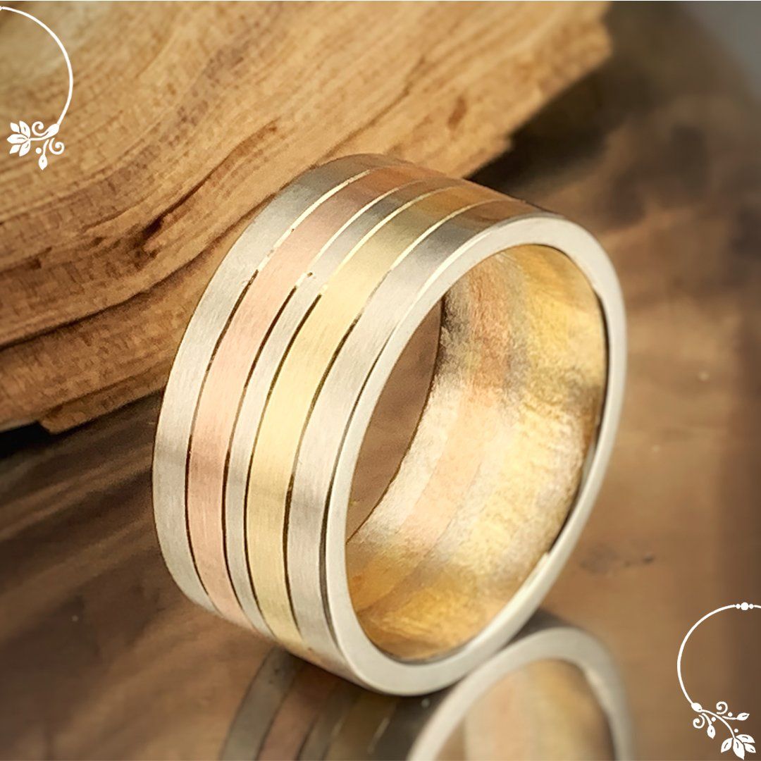 A ring is sitting on a table next to a piece of wood