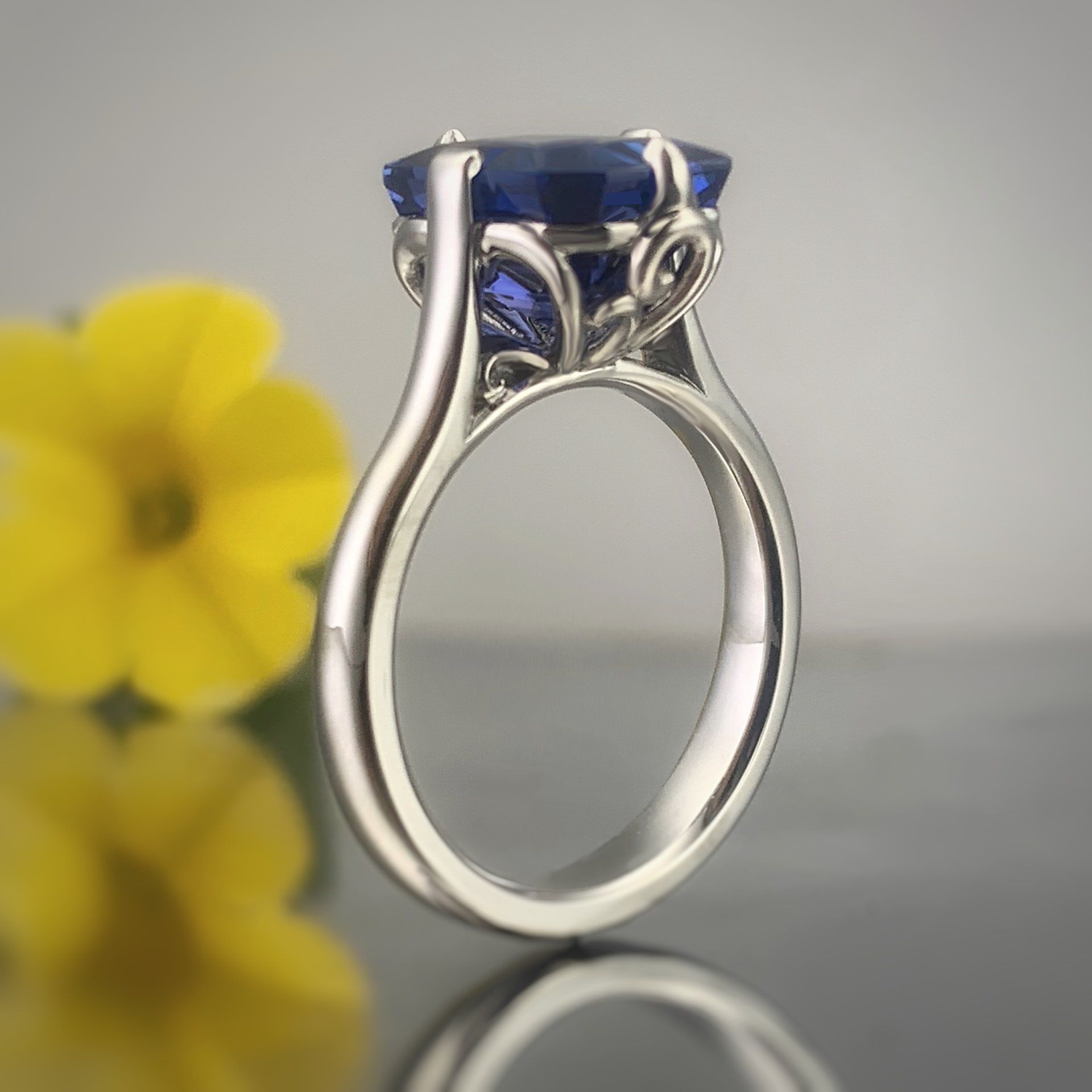 A silver ring with a blue stone in the center