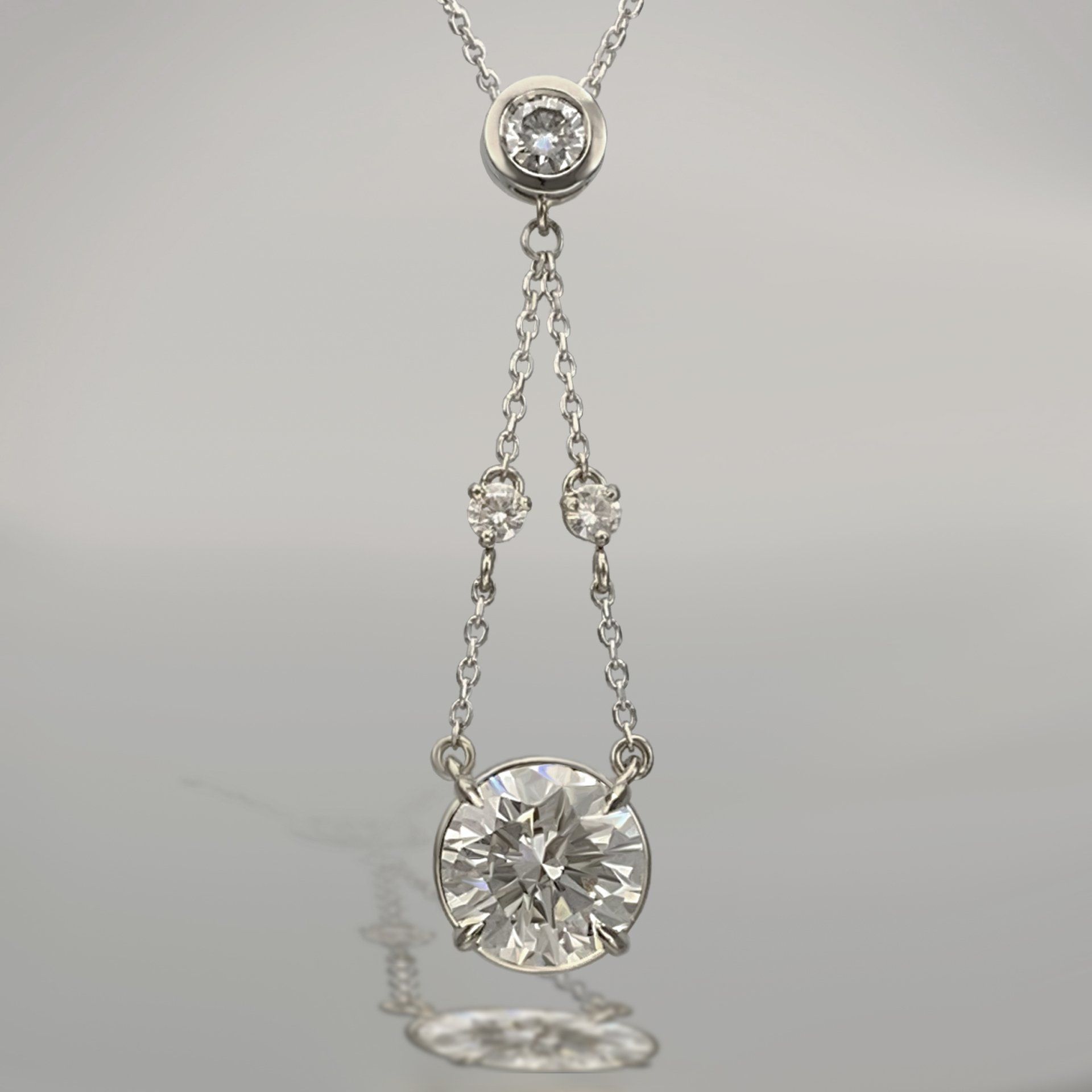 A necklace with a diamond pendant on a chain