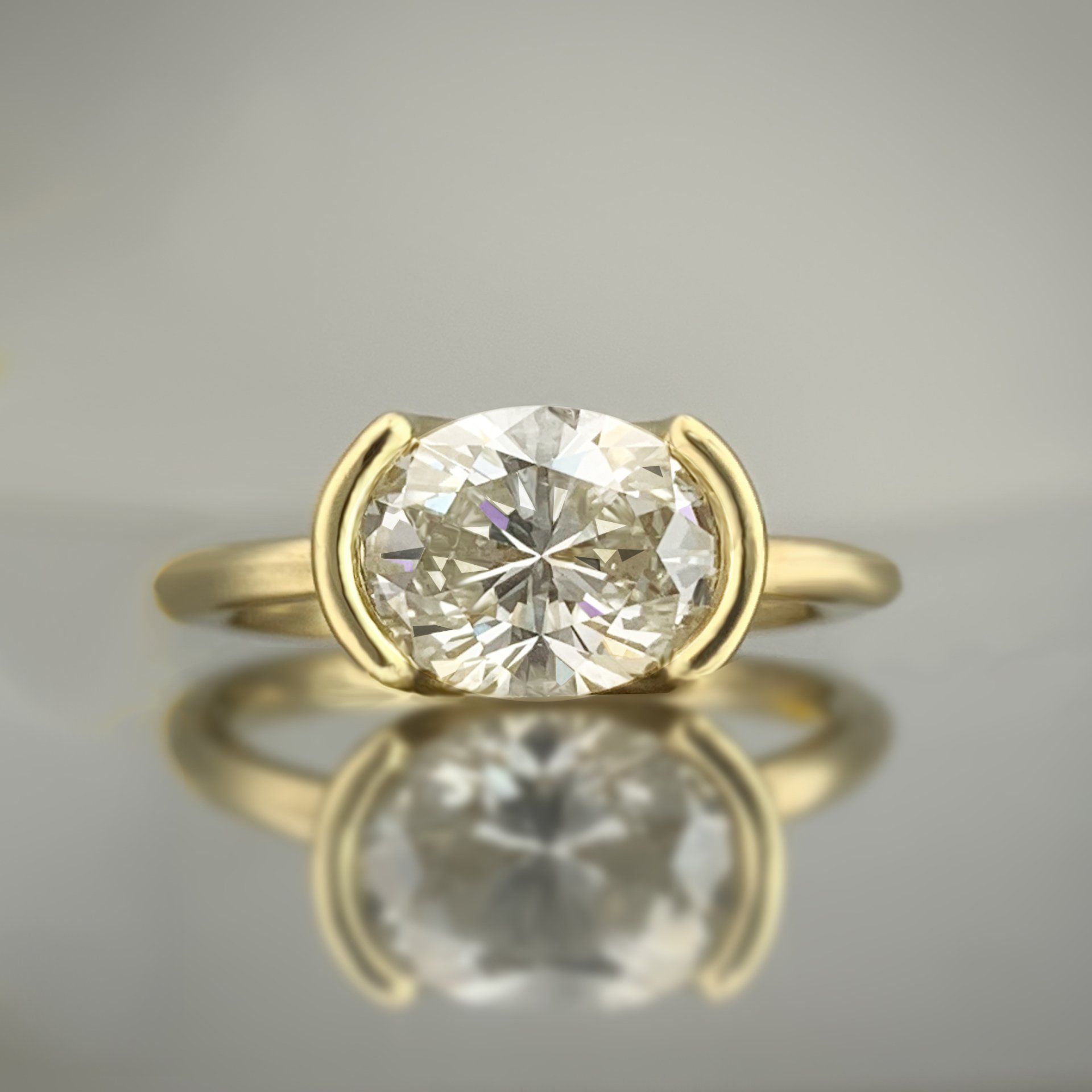 A yellow gold ring with a diamond in the center