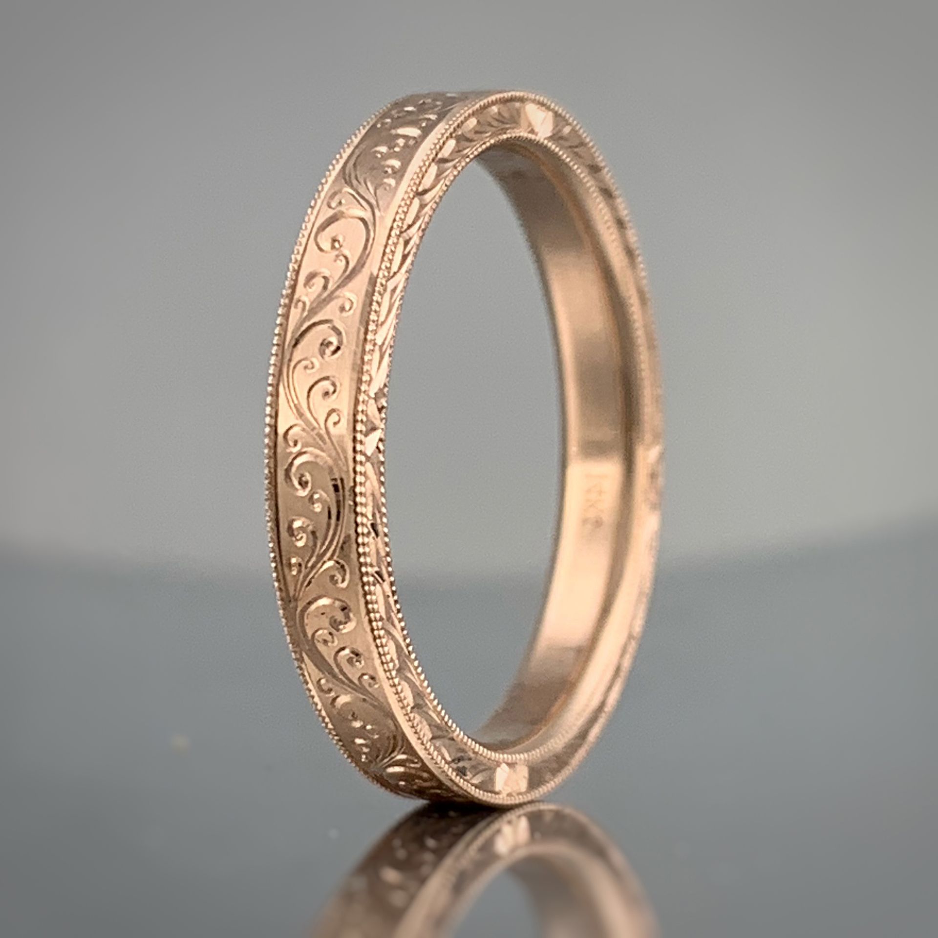 A yellow gold ring with a diamond in the center