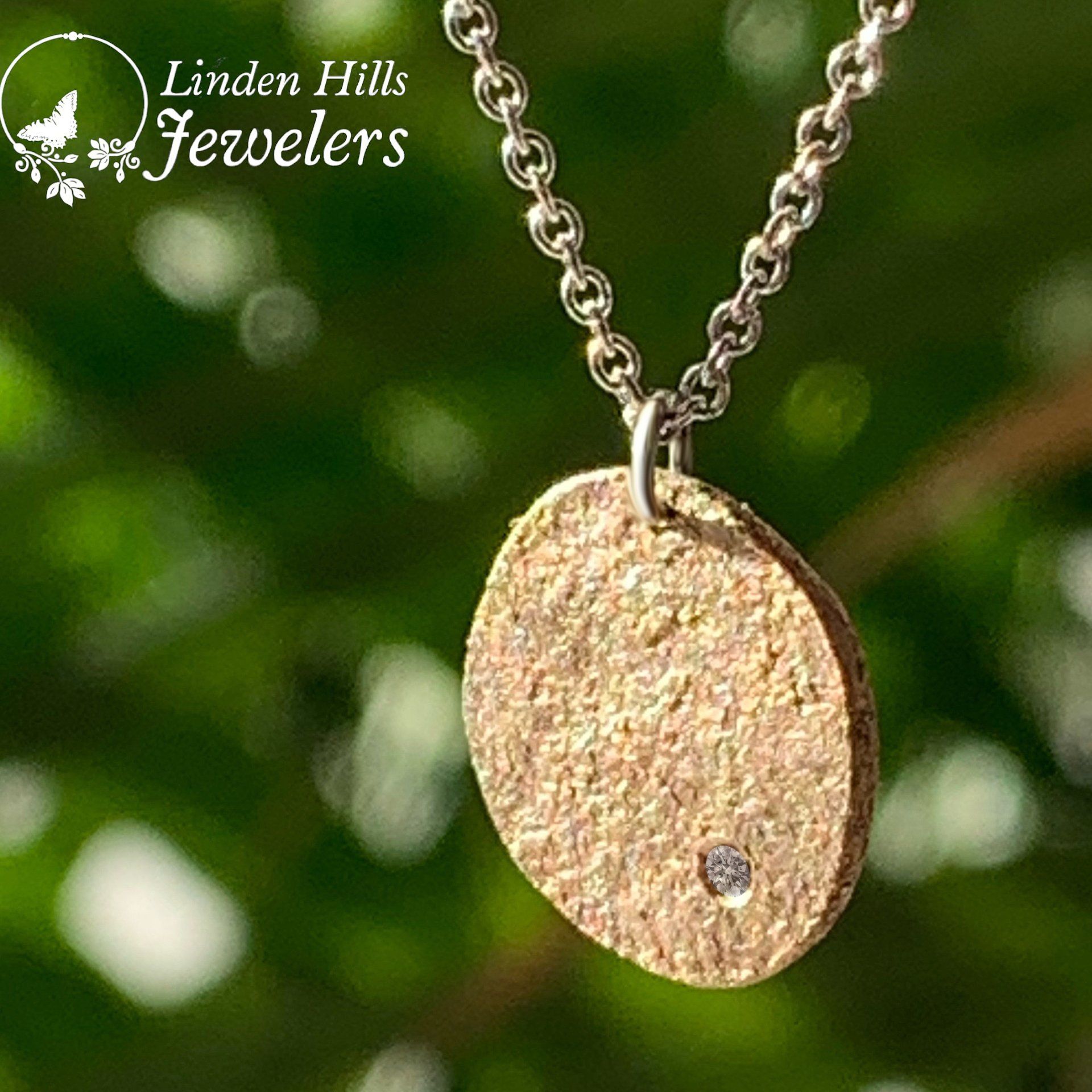 A close up of a necklace with a pendant on a chain.