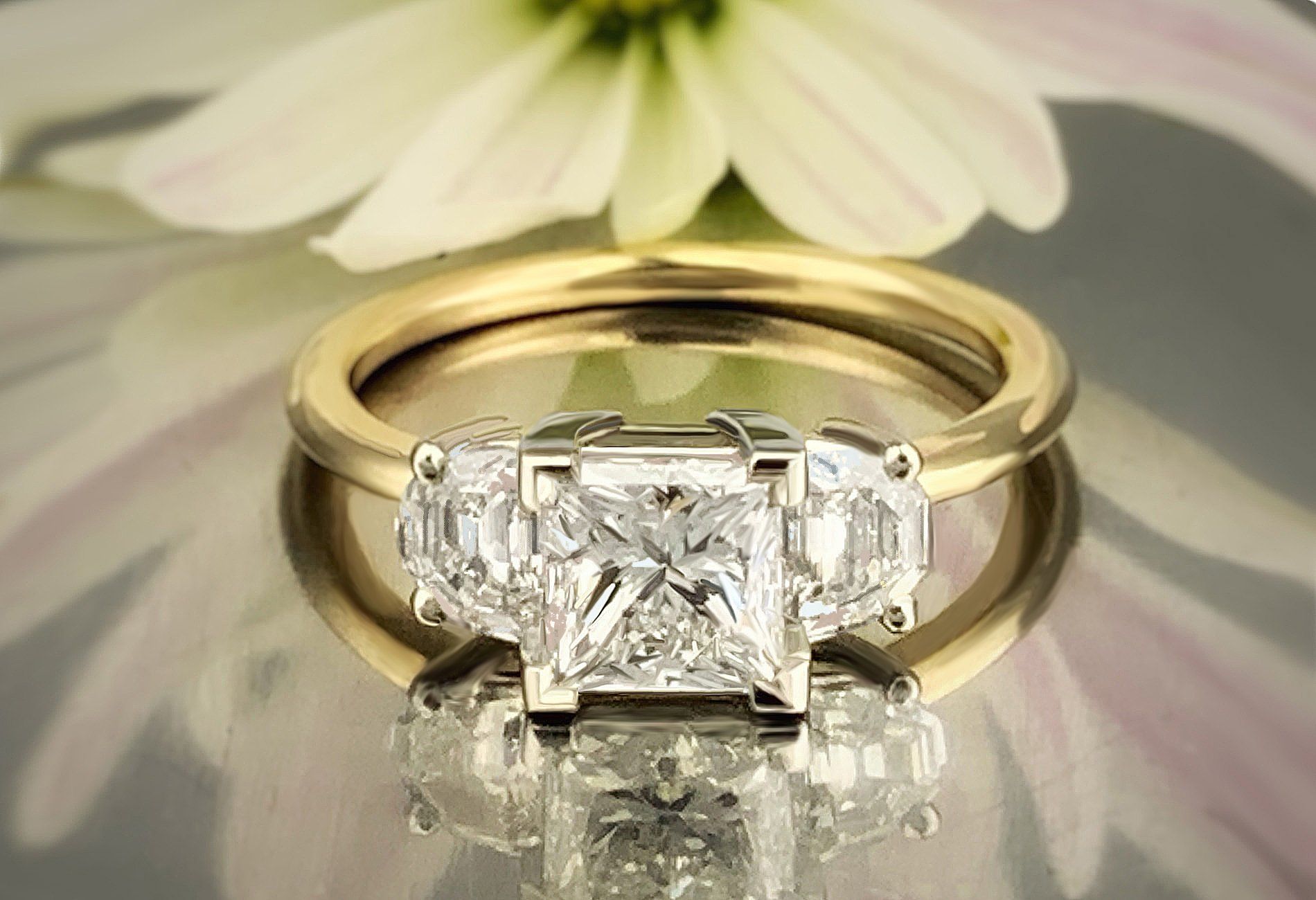 A diamond ring with a flower in the background