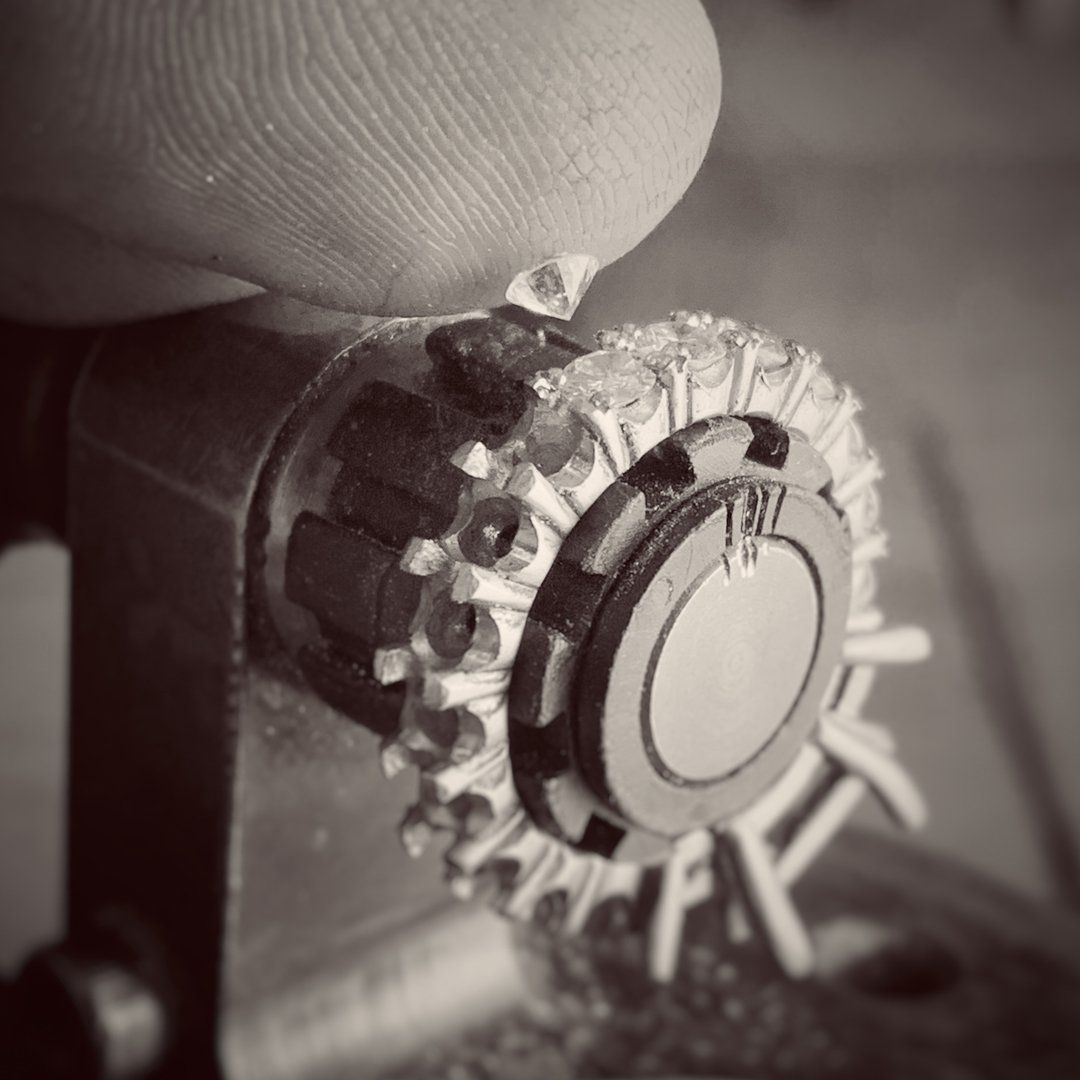 A black and white photo of a person holding a gear