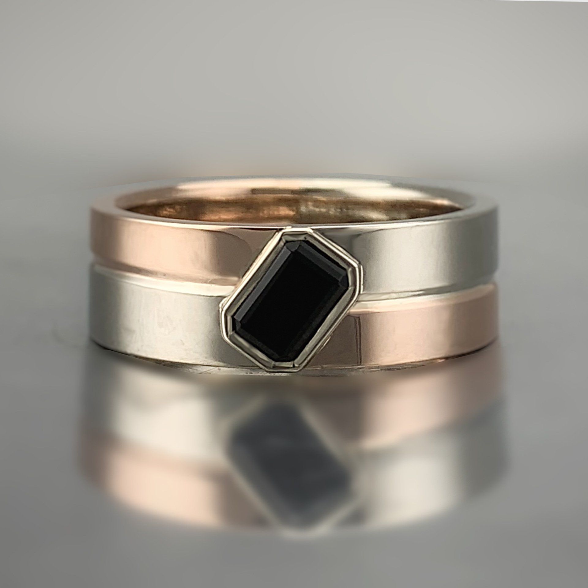 A couple of rings stacked on top of each other on a table.