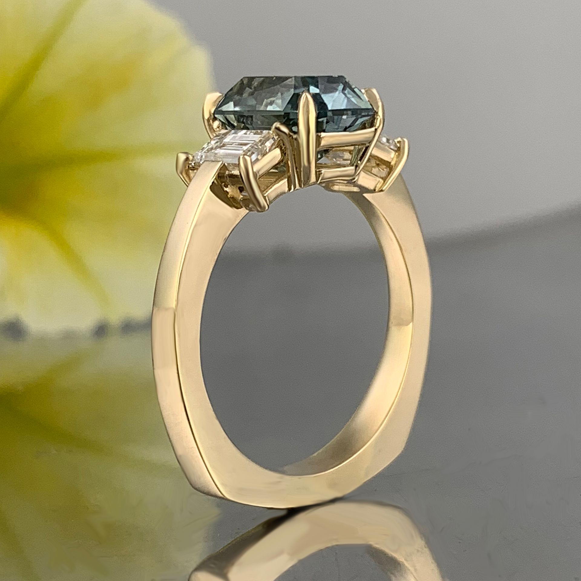 A yellow gold ring with a blue stone in the center