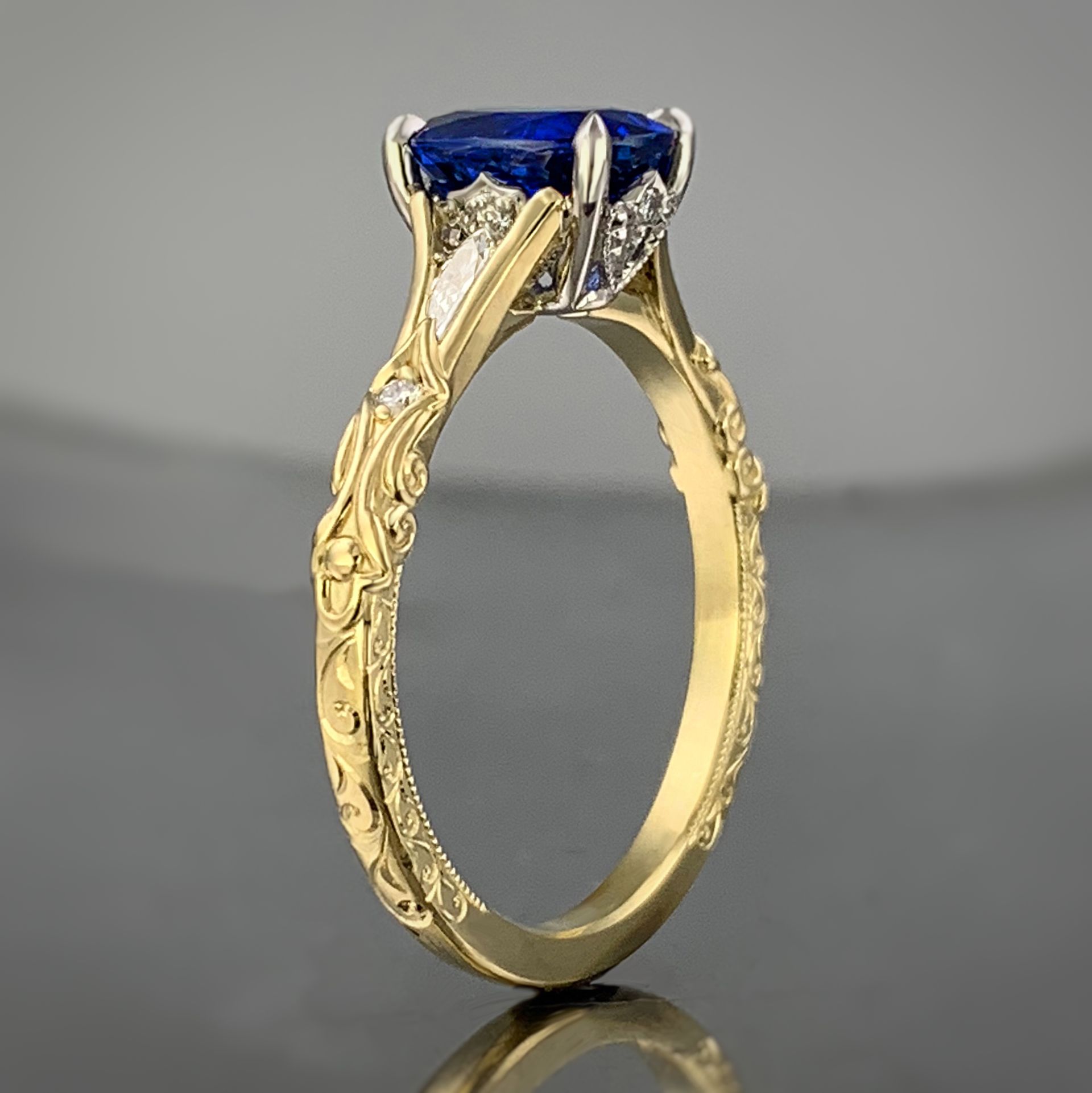 A yellow gold ring with a sapphire and diamonds