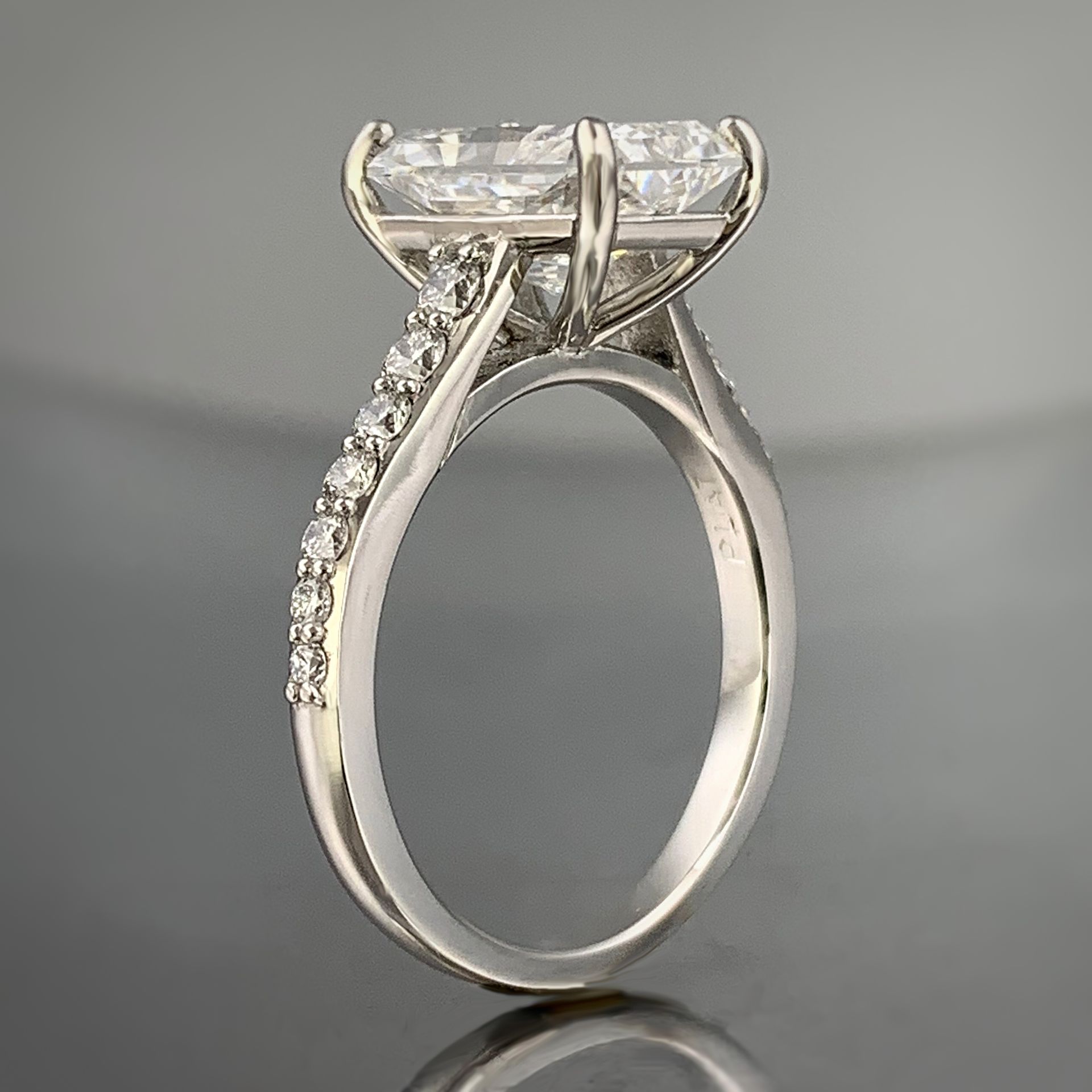 A white gold ring with a large diamond in the center