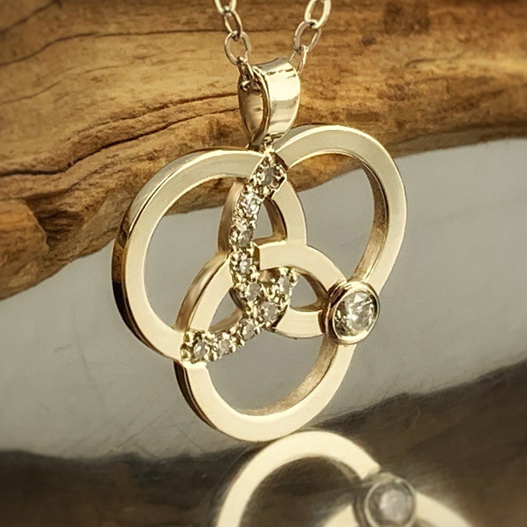 A gold necklace with a diamond in the center