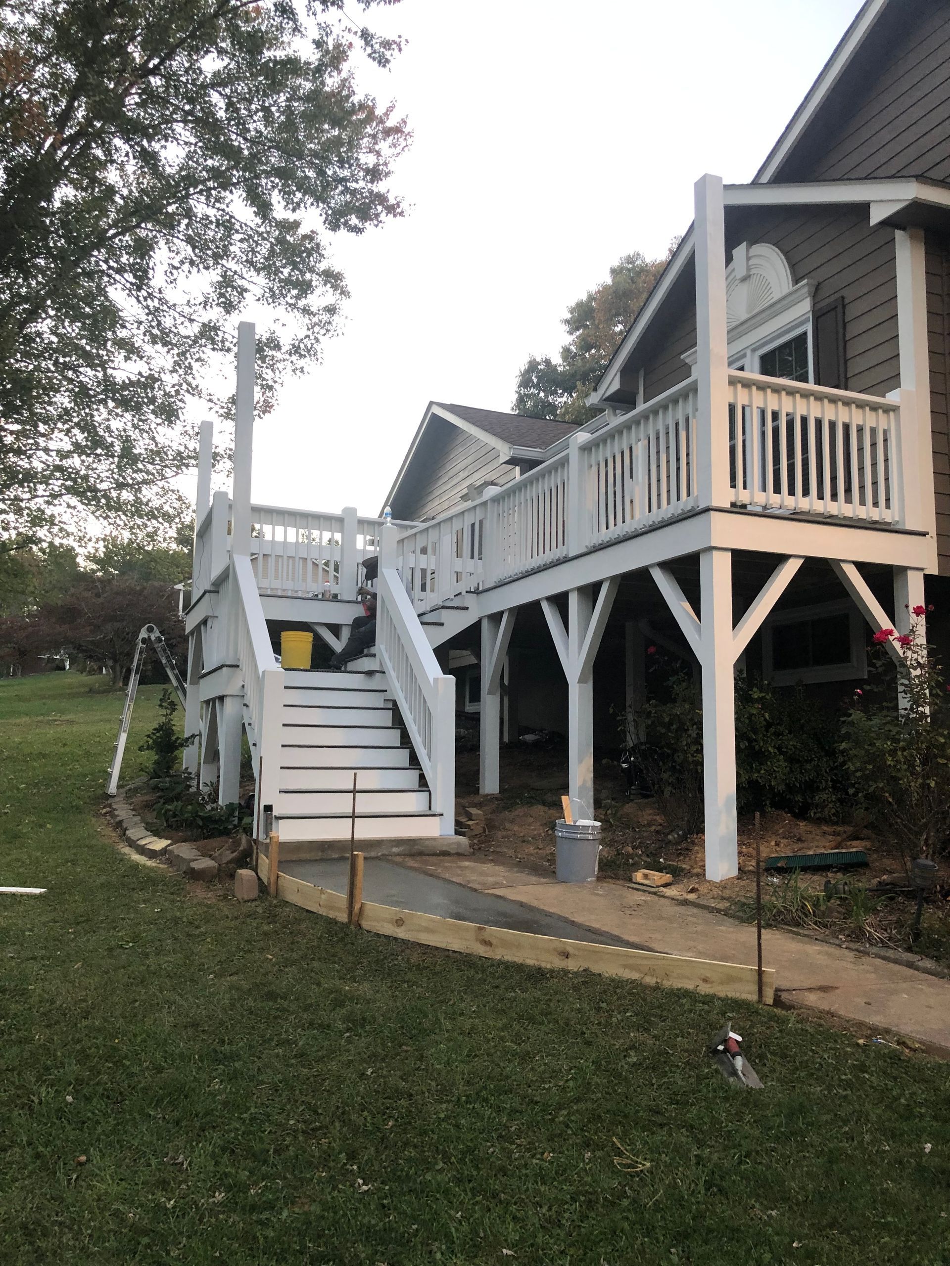 A house with a large white deck and stairs