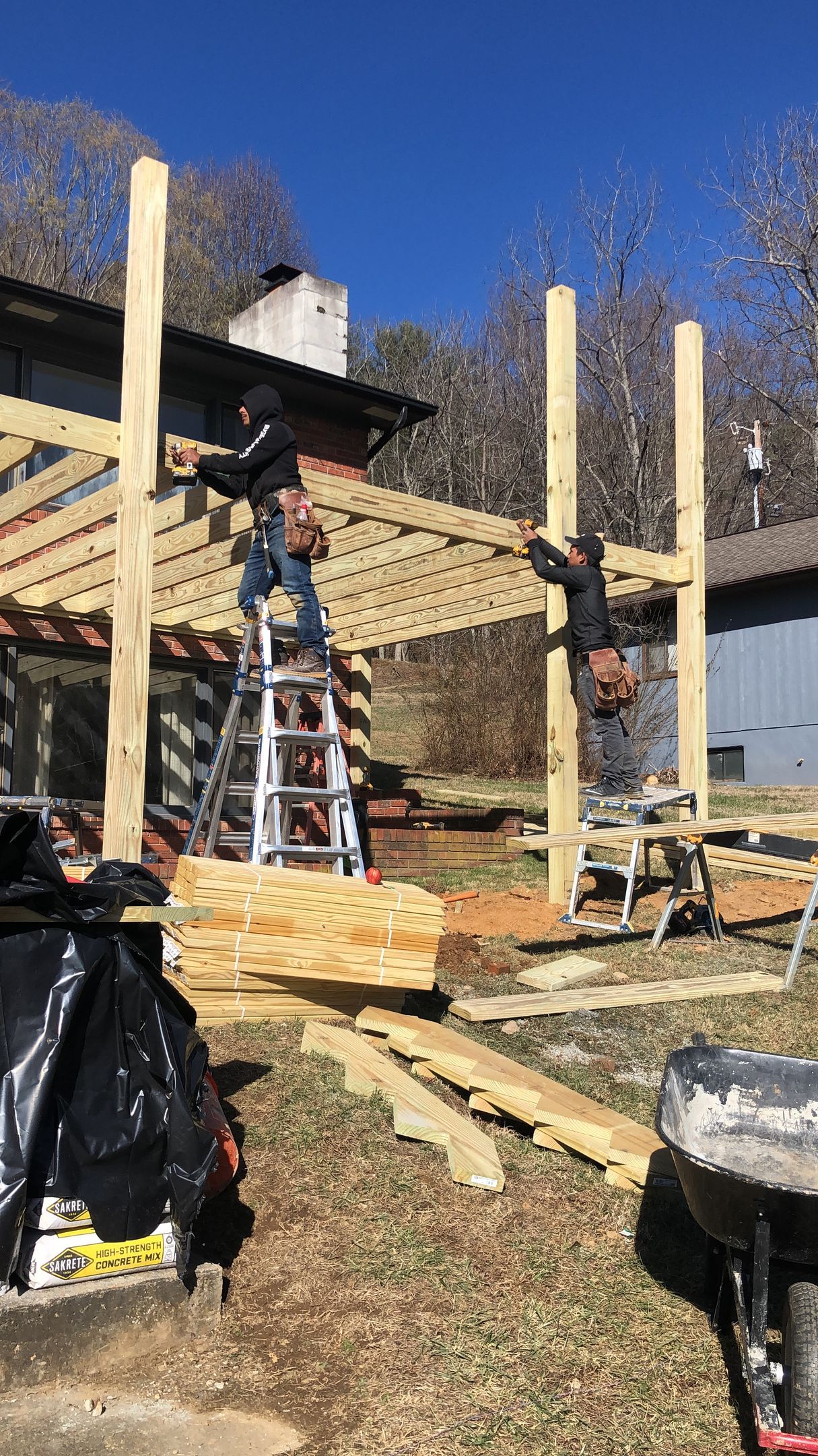 A group of men are working on a wooden structure.