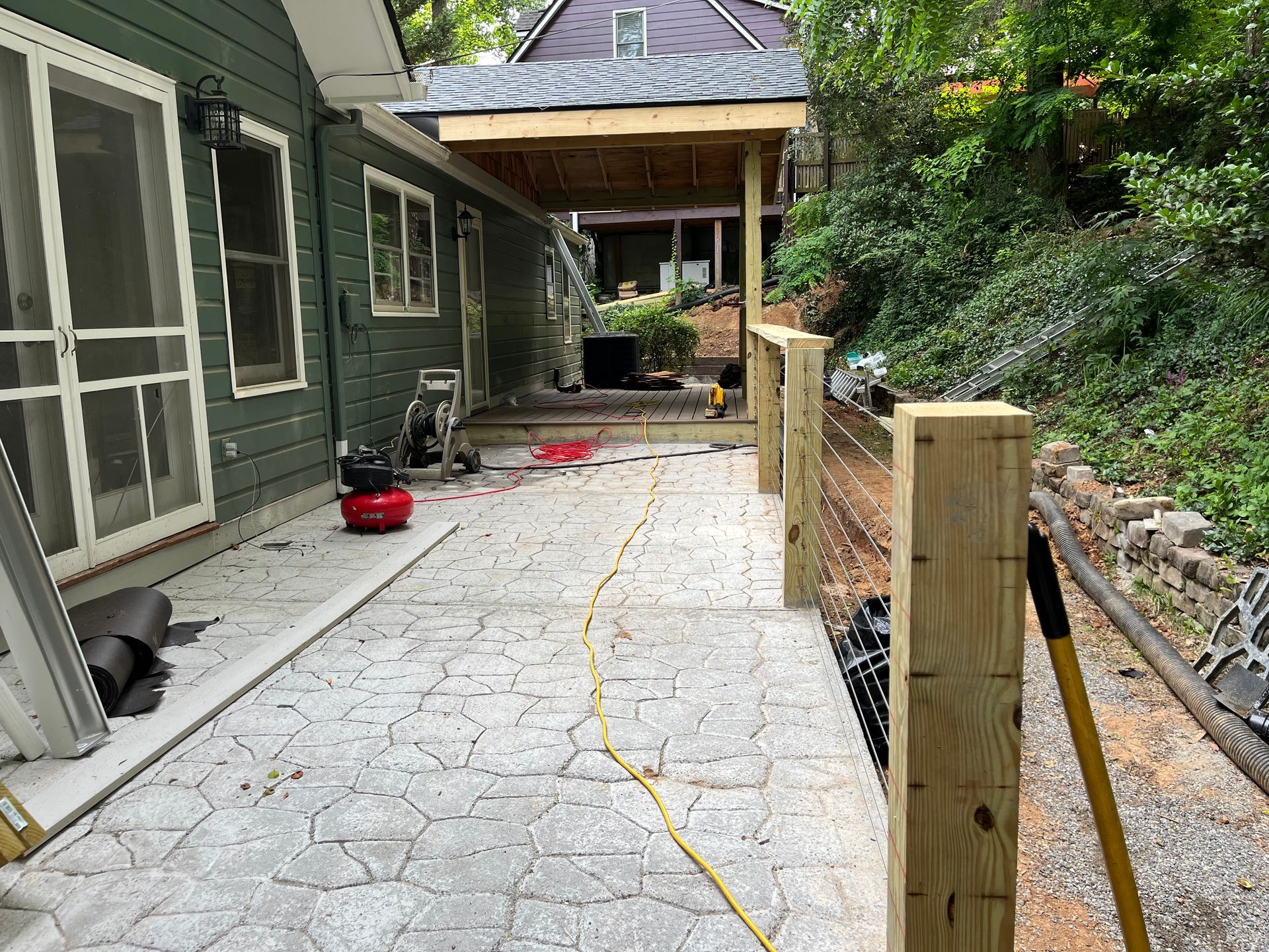 A patio is being built in front of a house.