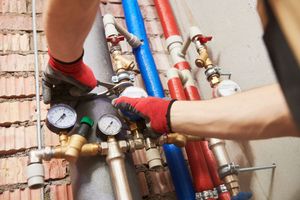 A man is working on a water pipe system.