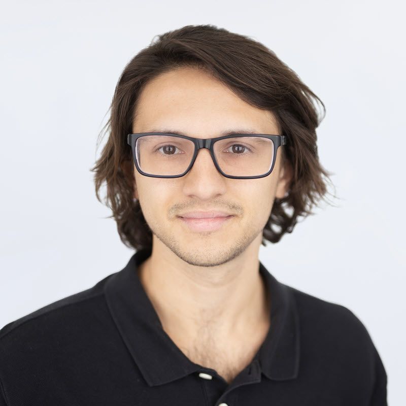 Agent Brady wearing glasses and a black polo shirt