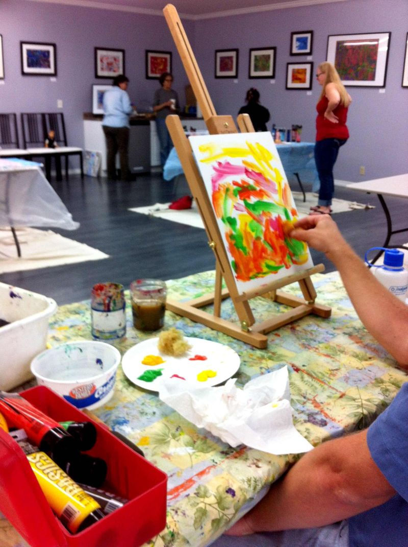 Colorful German Shepherd dog lying in front of a soda fountain.