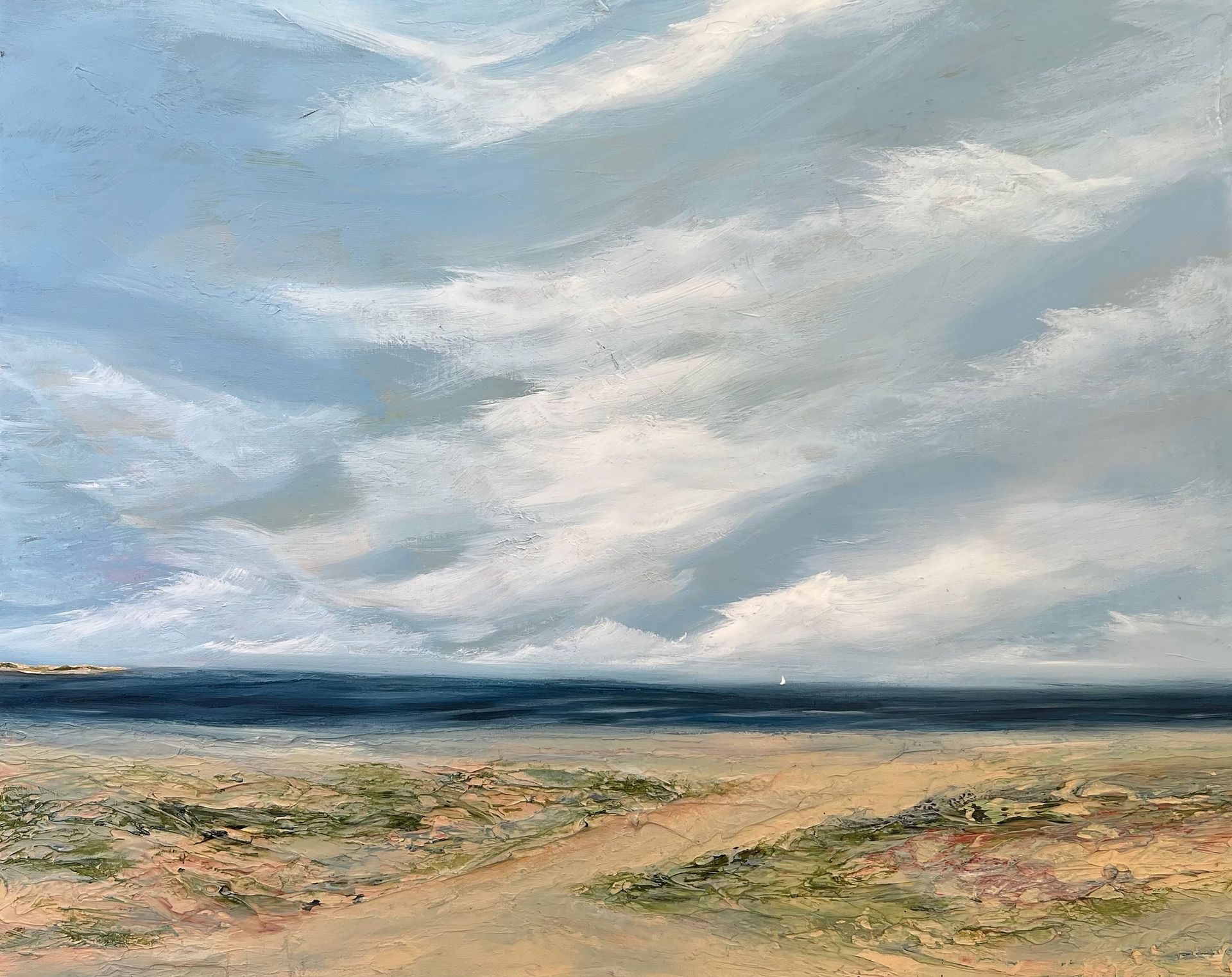 Coastal landscape with a sandy beach, dark blue ocean, and cloudy sky; mostly light blues and earth tones.