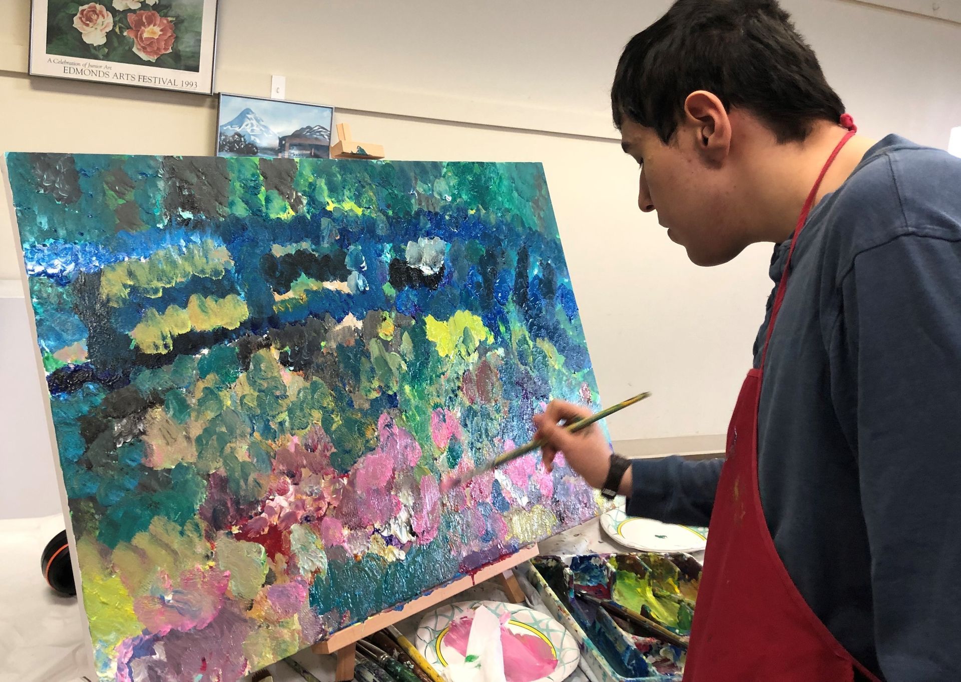 Boats docked in a harbor, city buildings in the background, with red, gray, and turquoise hues.