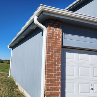 A garage with a white door and a brick chimney