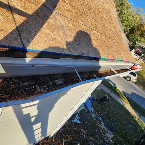 A gutter is being installed on the roof of a house.