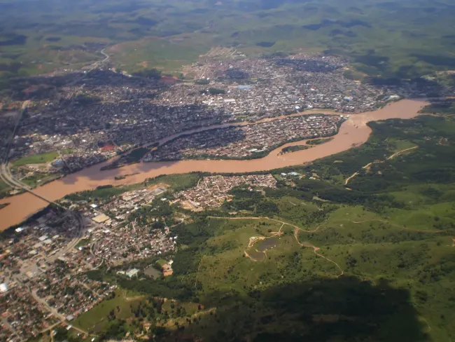 Vista aérea de Governador Valadares e o Rio Doce fluindo através da cidade.