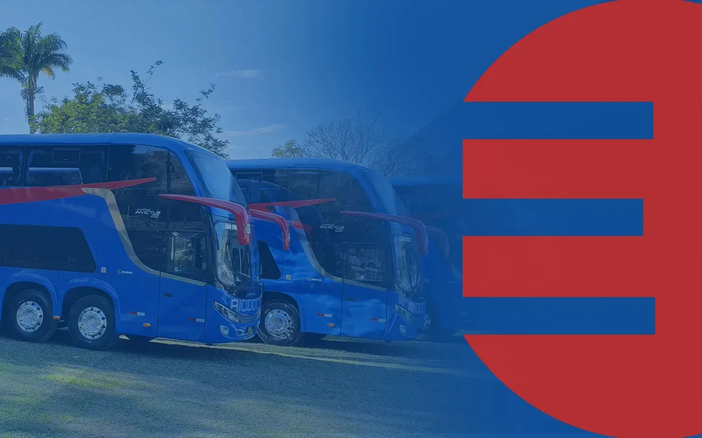 Dois ônibus azuis de dois andares estão estacionados um ao lado do outro em um campo.