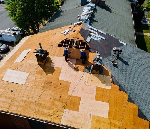 Construction worker on renovation roof the house installed new shingles 