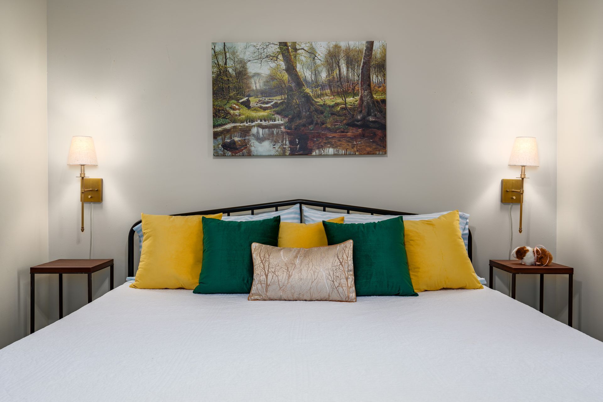 There is a painting on the wall above the bed.