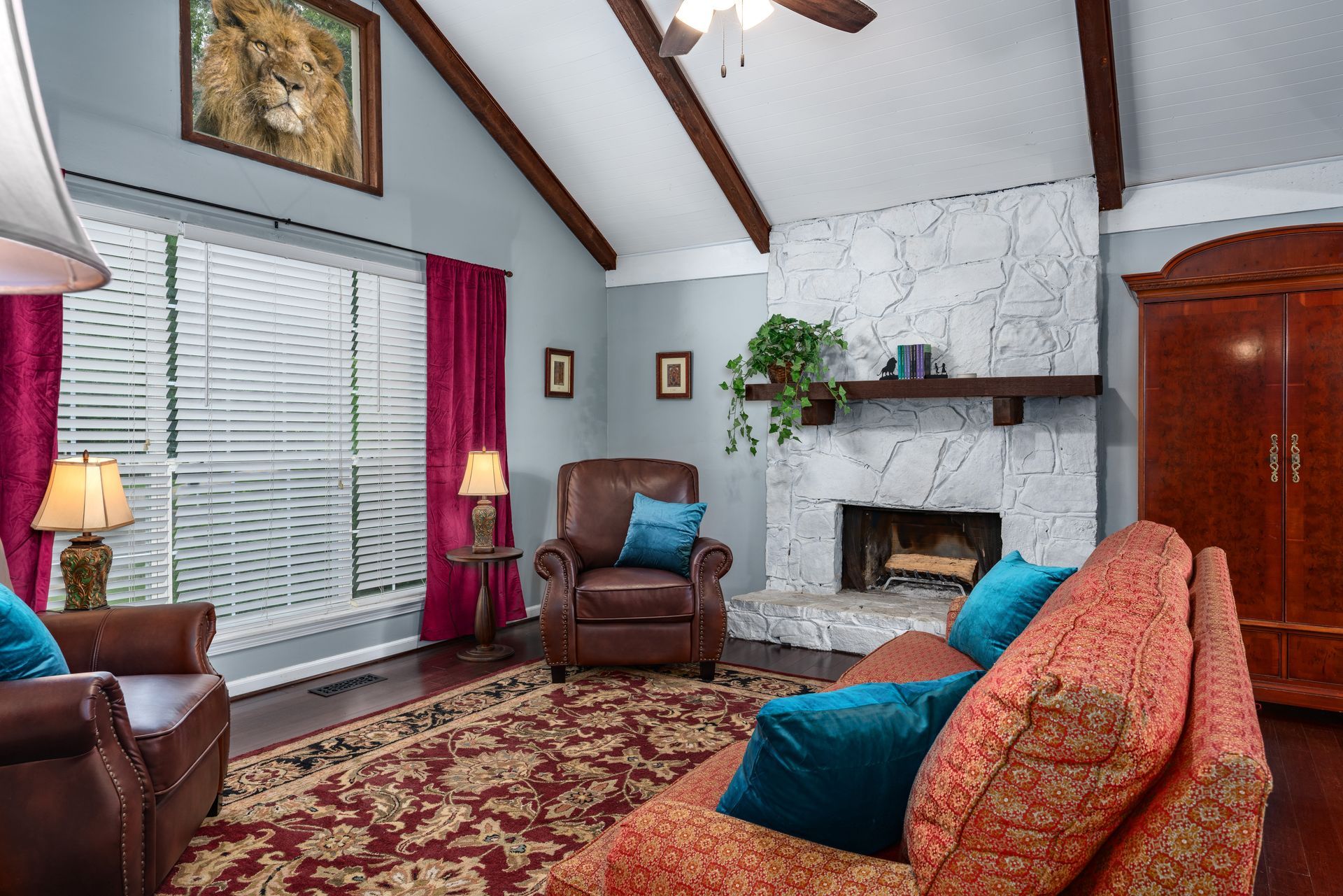 A living room with a couch , chair , and fireplace.