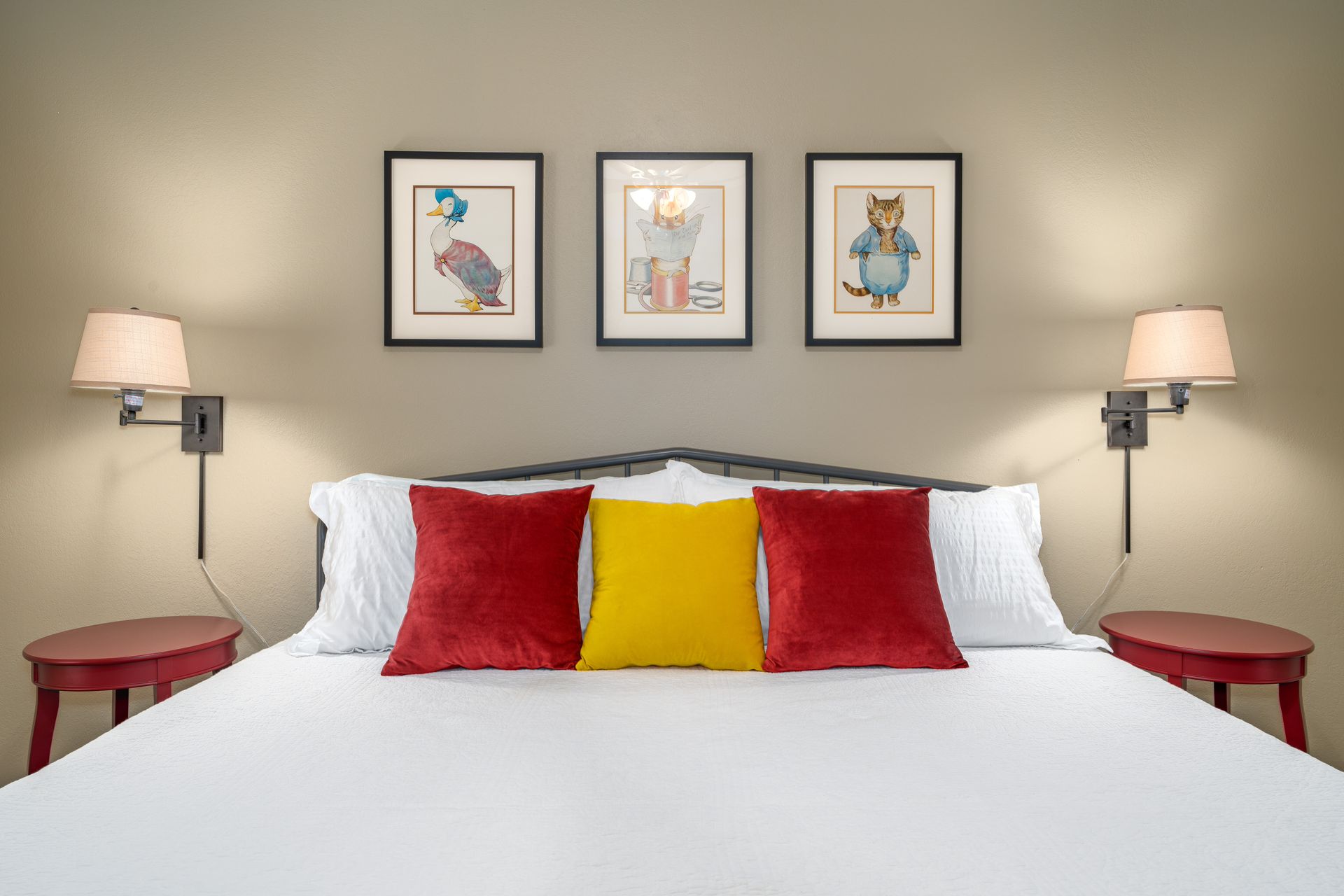 There are three pictures on the wall above the bed.