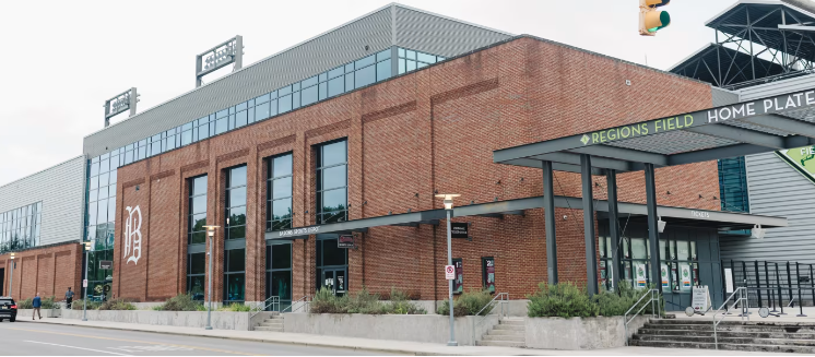 Brick building with large windows and a sign that reads 