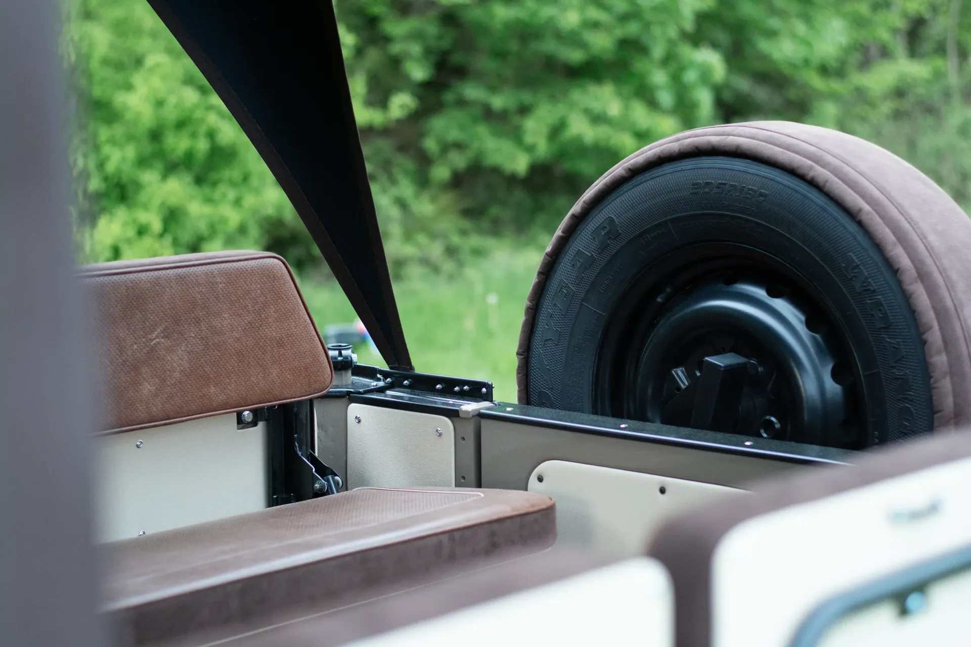 A close up of a tire on the back of a car.