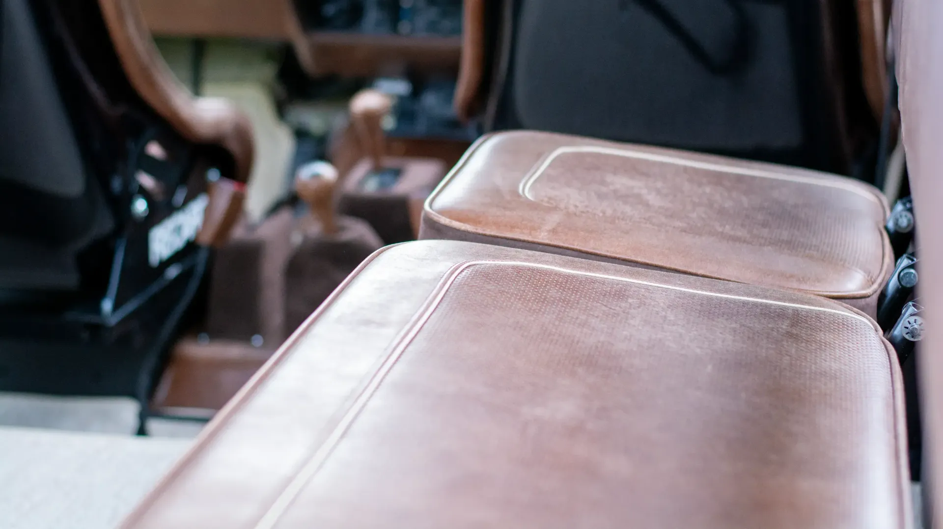 A close up of a brown leather seat in a car.
