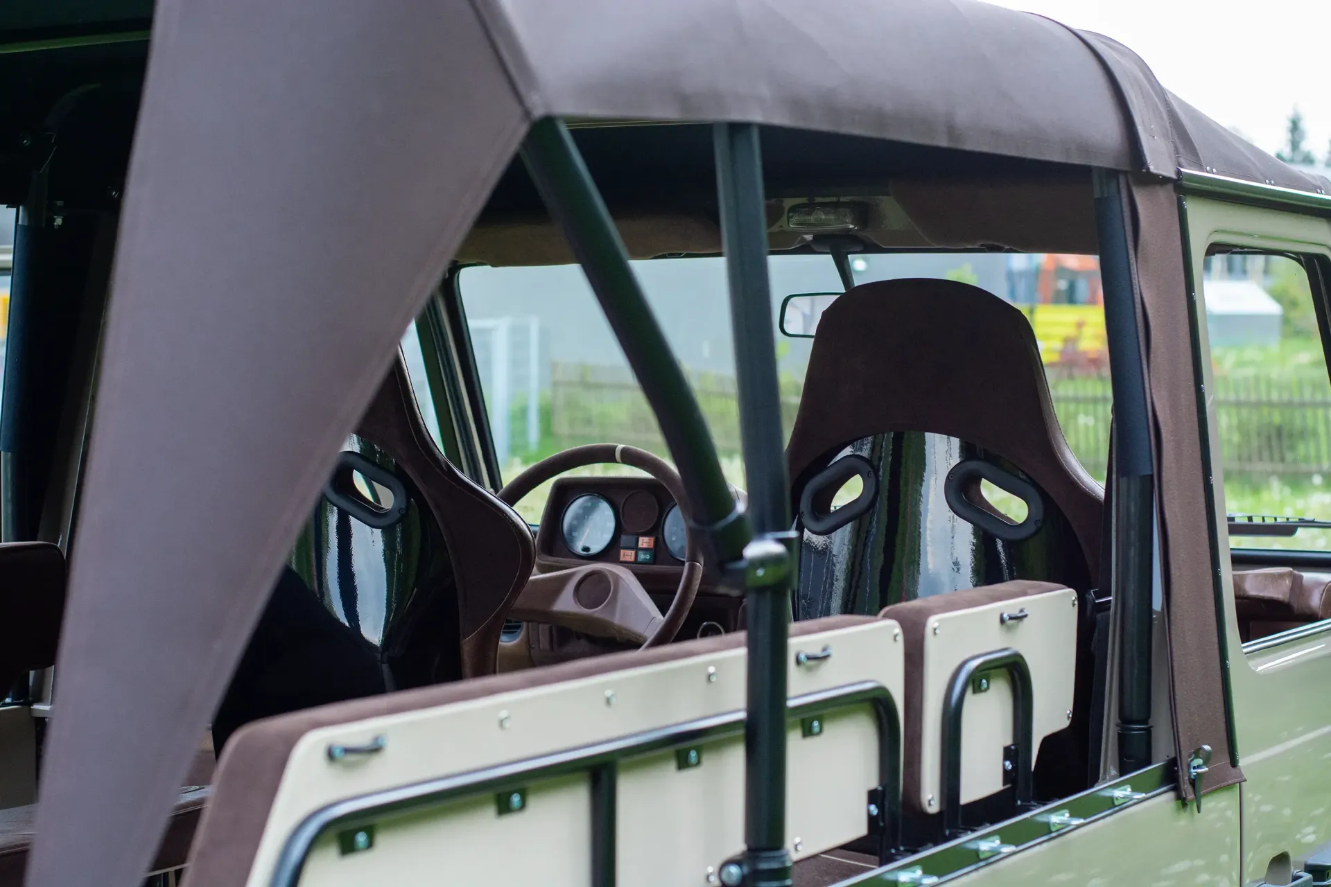 The inside of a G-Wagon with a steering wheel and seats