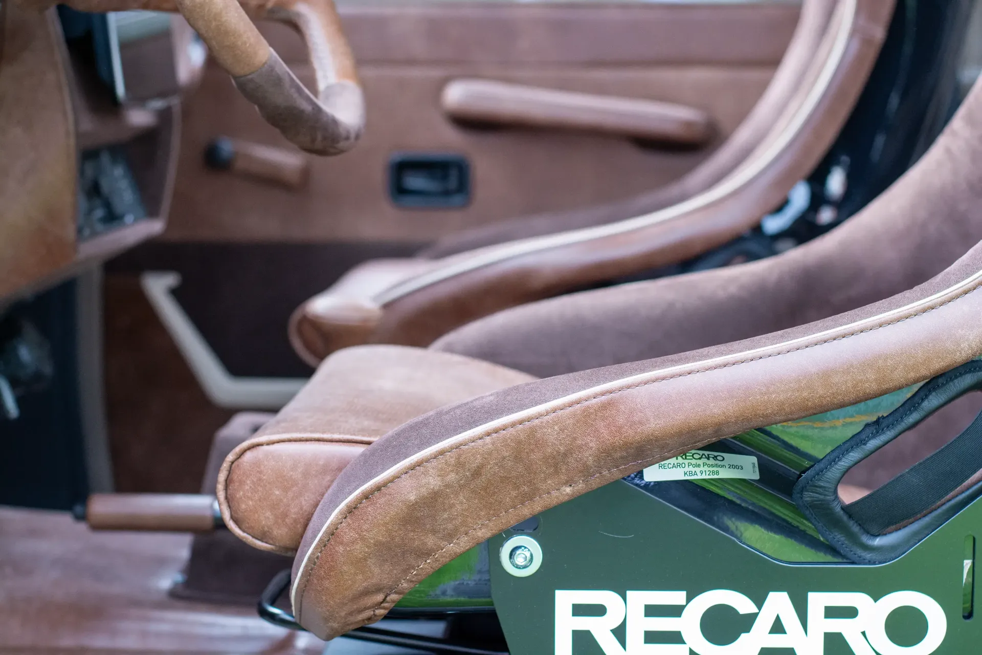 A close up of a recaro seat in a car