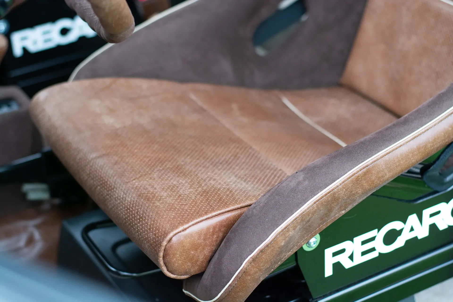 A close up of a recaro seat in a car